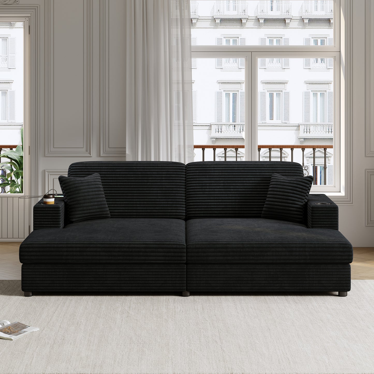 Black corduroy sectional sofa with throw pillows and integrated cup holders