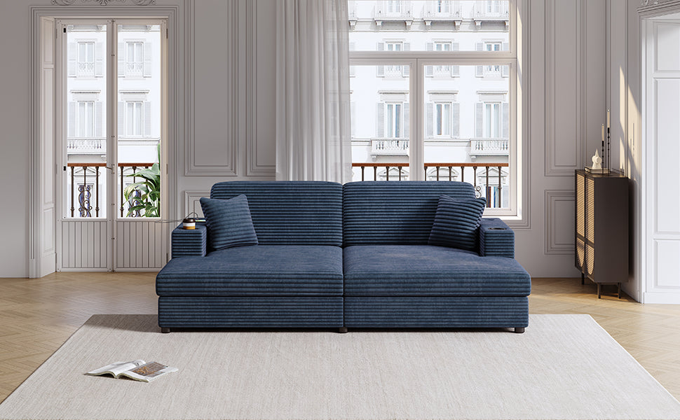 Navy blue corduroy sofa with tufted pillows and builtin cup holders