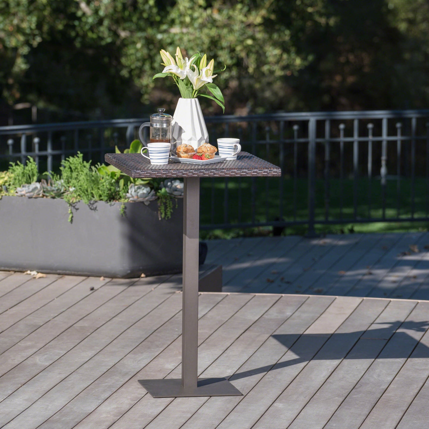 Brown wicker outdoor bar table with square metal base