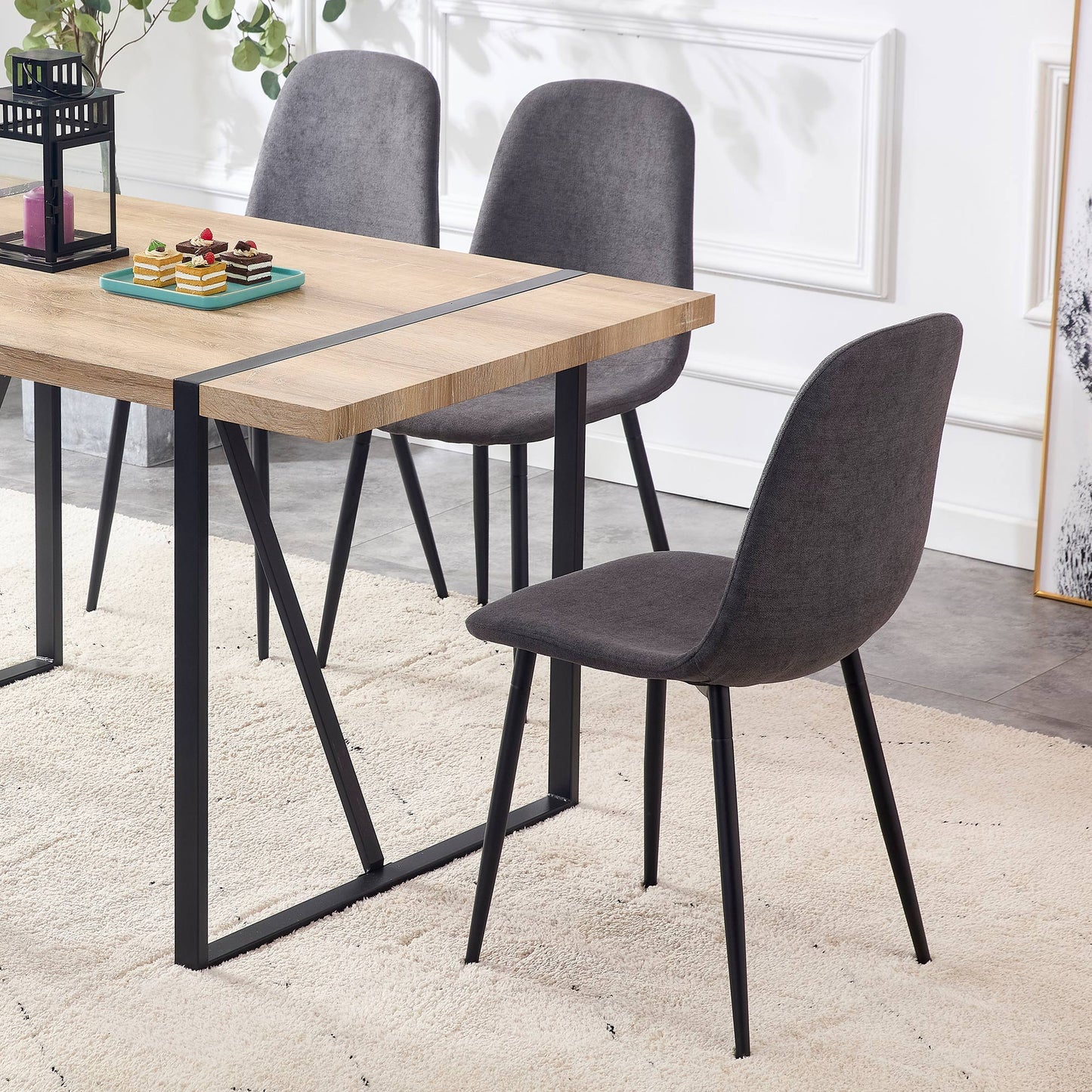 Modern gray fabric dining chair with black metal legs perfect for contemporary kitchens