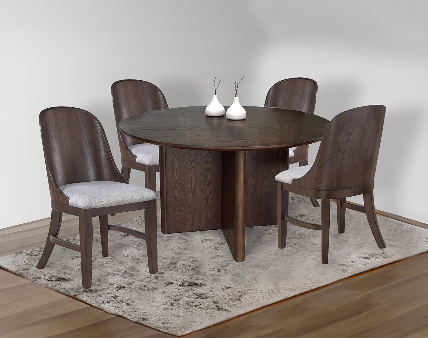 Dark wood round dining table with four matching chairs with grey upholstered seats