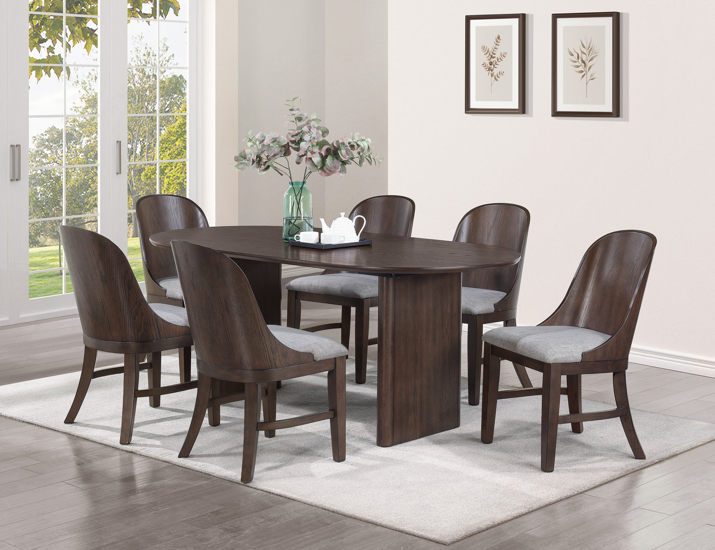 Dark wood oval dining table with six upholstered grey chairs
