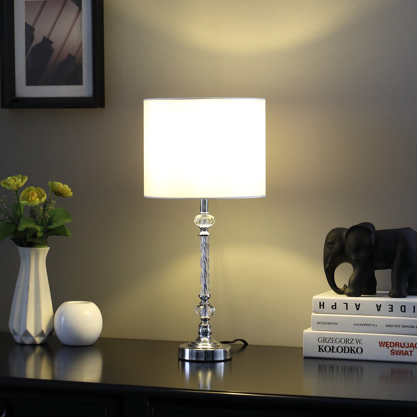 Elegant chrome table lamp with a white drum shade and crystal accents