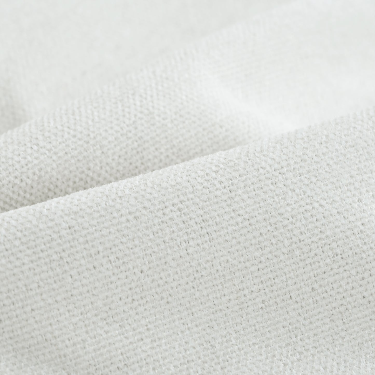 Closeup of a textured white linen fabric showcasing its natural fibers and weave for home decor