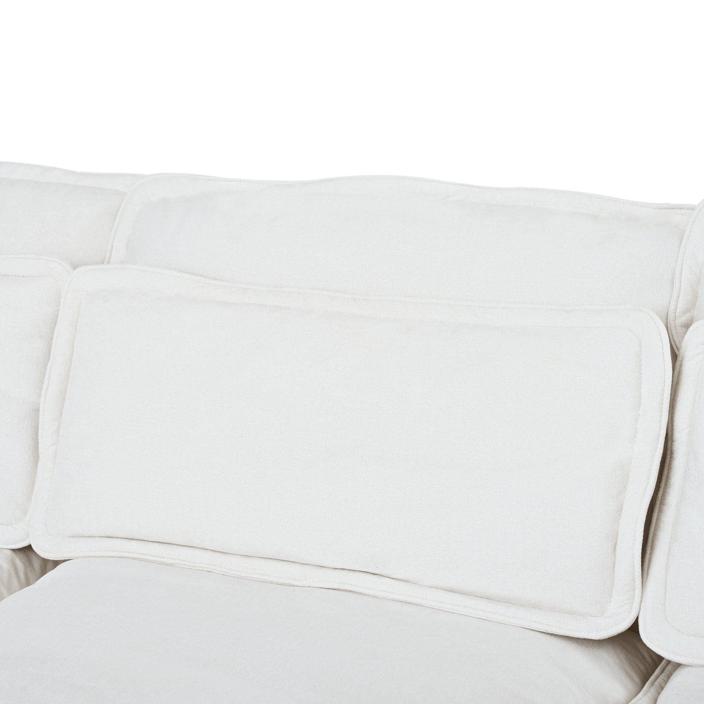 Closeup of textured white linen sofa cushions with soft piped edges perfect for a cozy living room