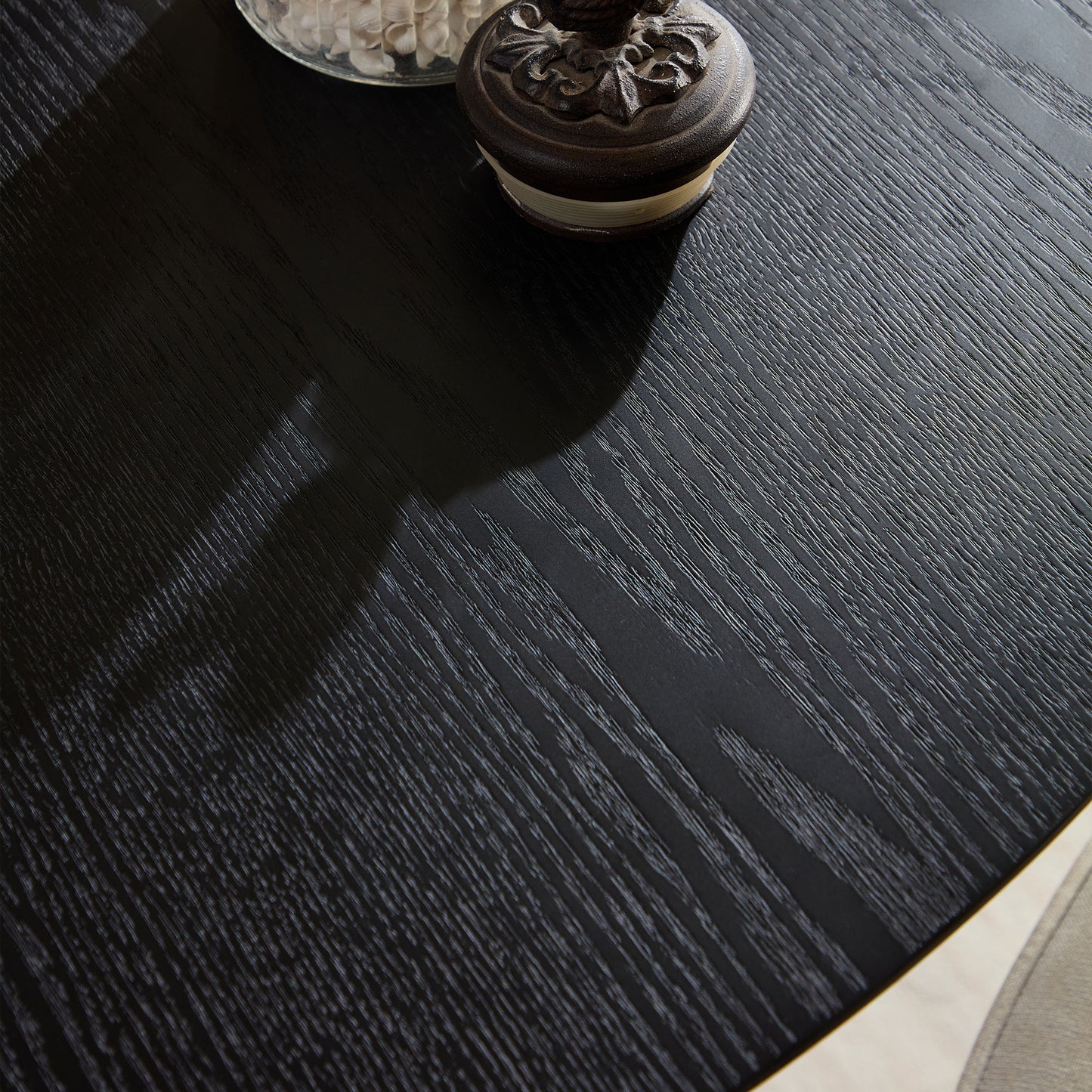 Black oak wood grain table surface with decorative jar detail modern dining furniture