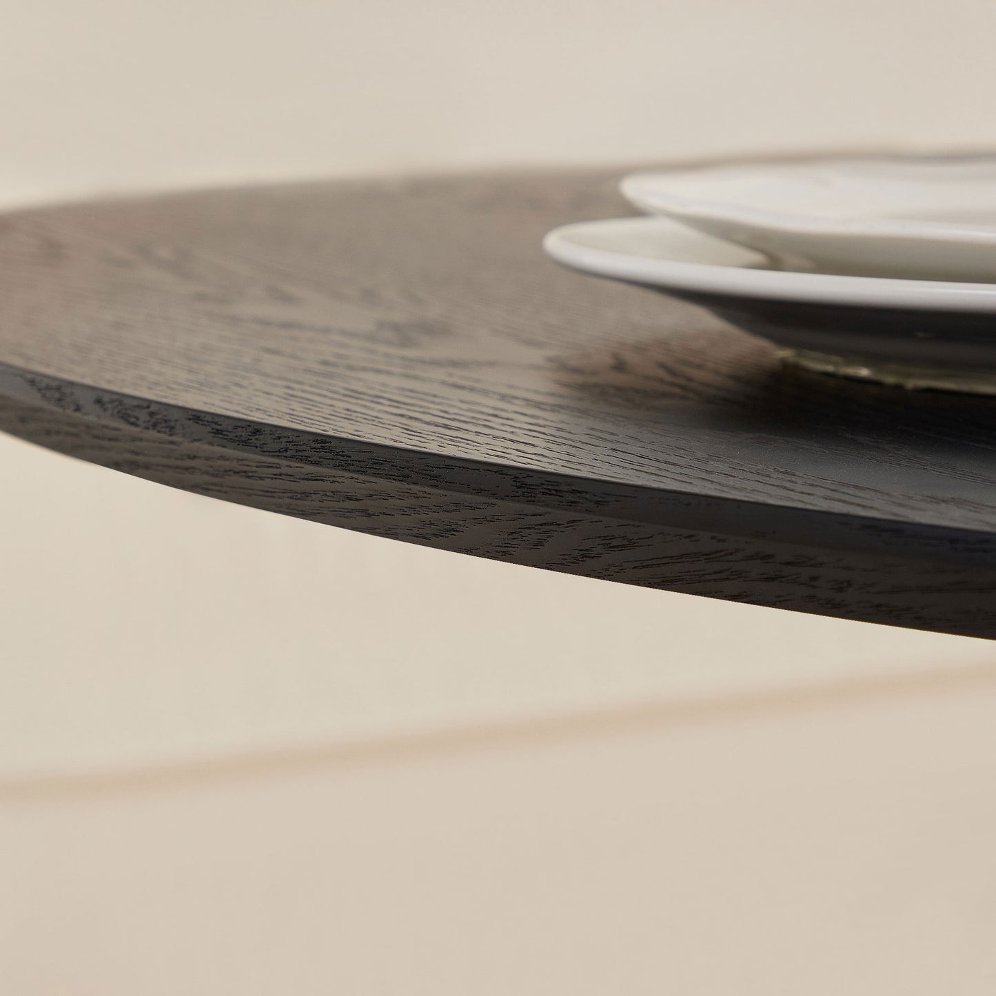 Closeup of dark oak dining table edge with visible grain detail