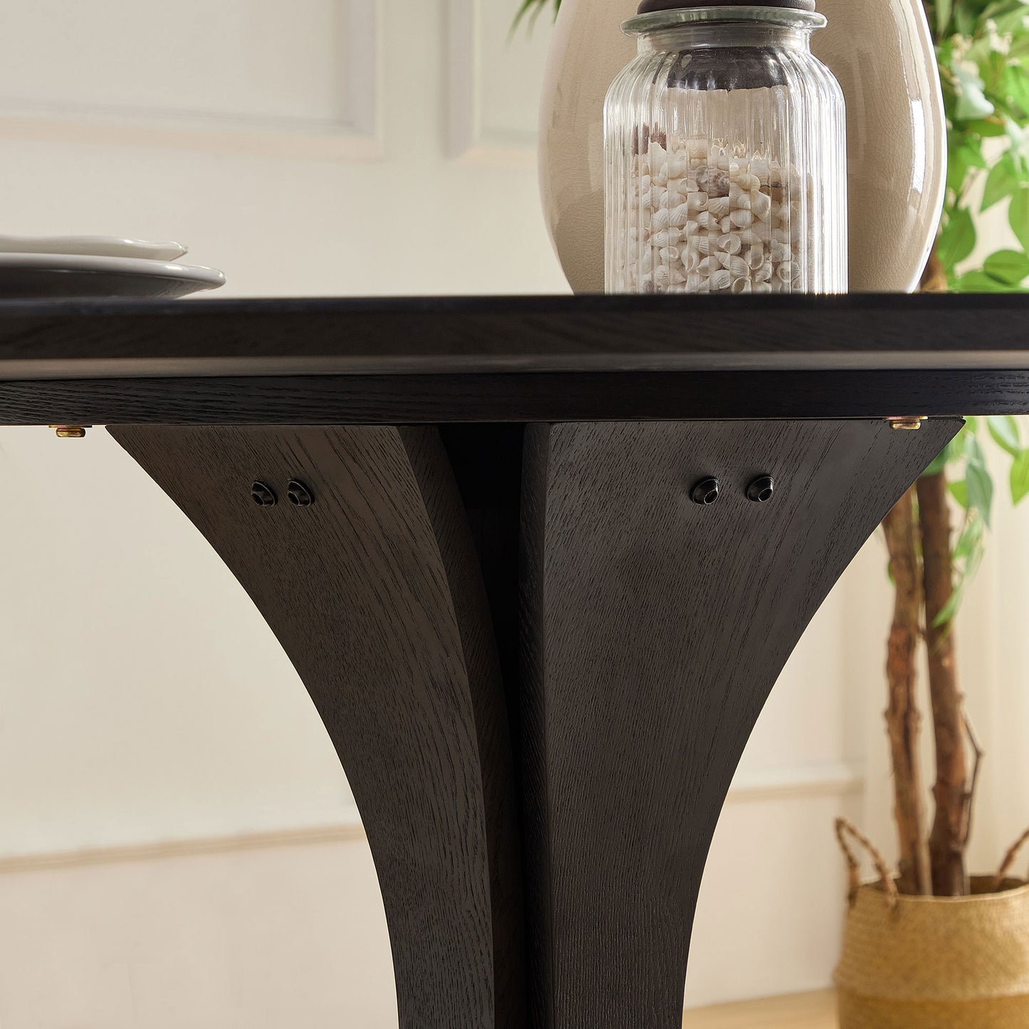 Closeup of a dark oak dining table leg with carved details ideal for modern homes