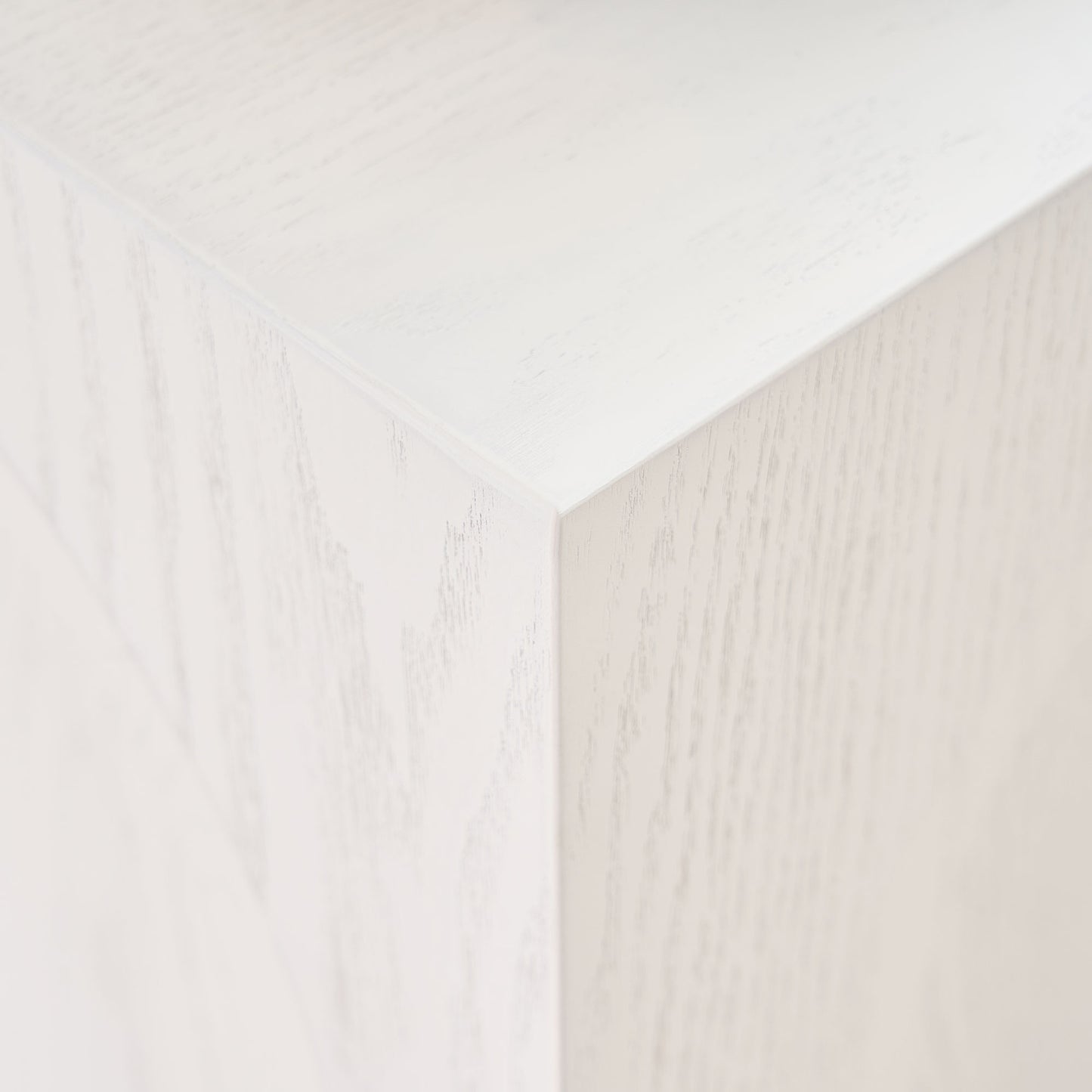 Closeup of a white washed wood veneer corner showcasing fine grain texture