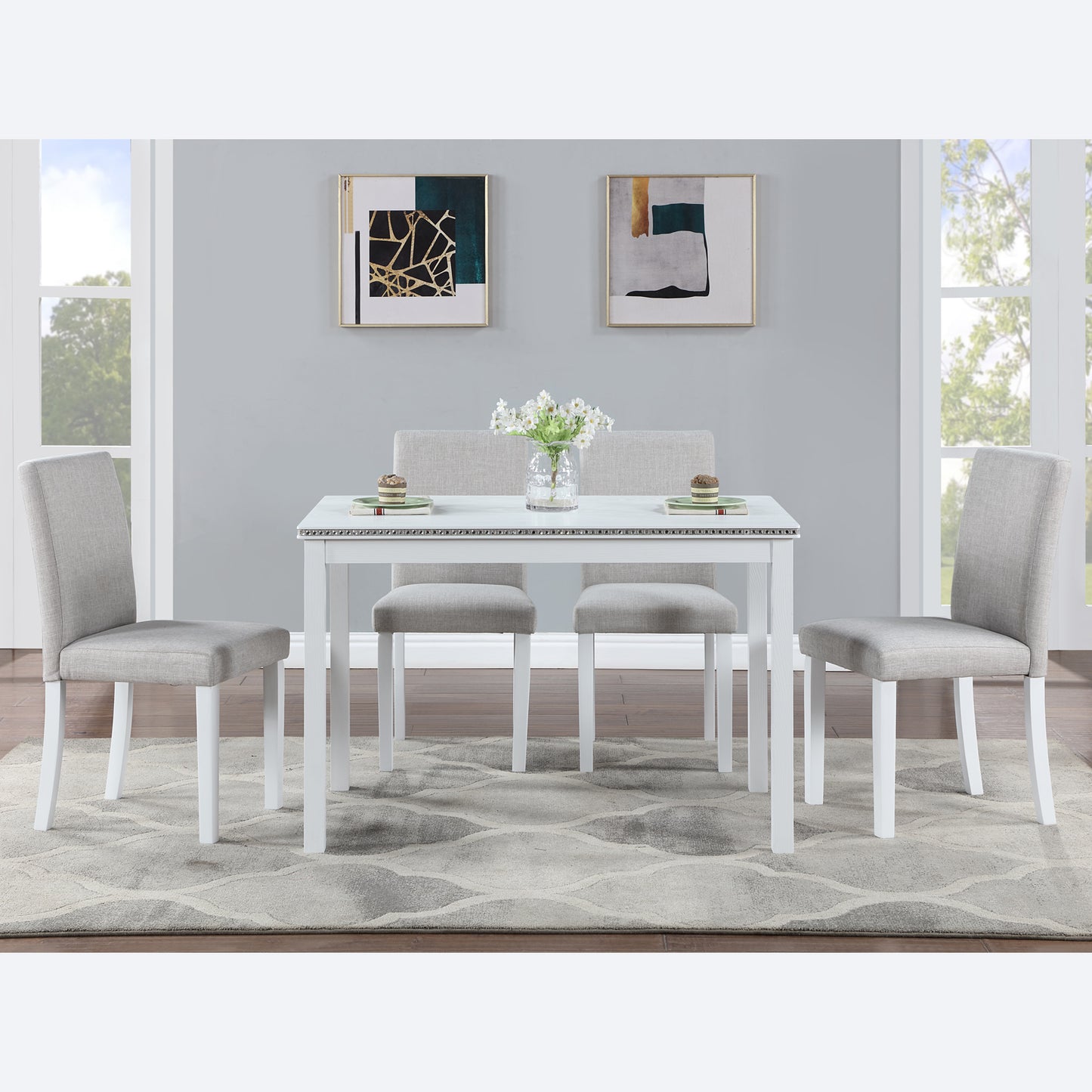White modern dining table with four grey upholstered chairs