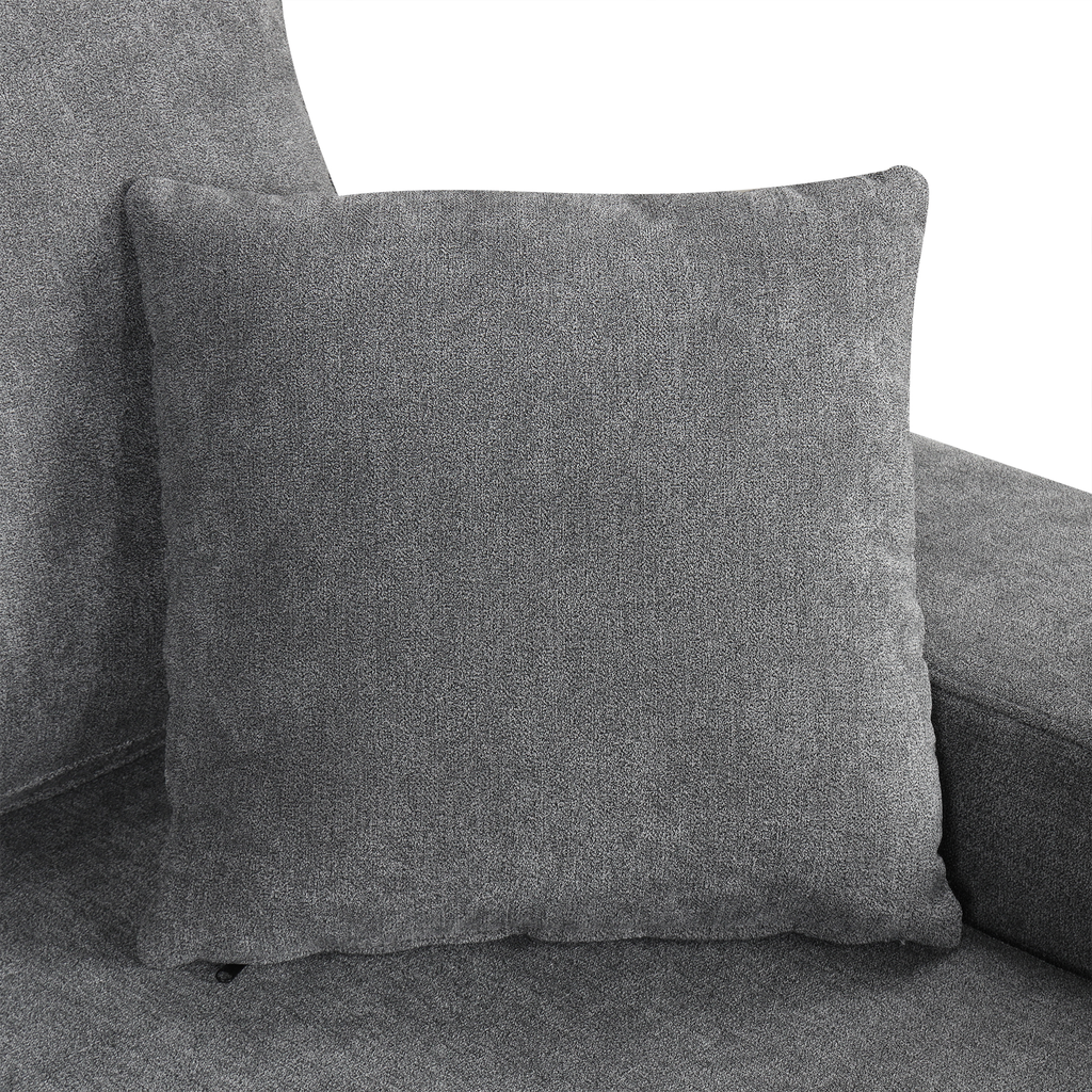 Plush gray accent pillow with textured fabric on a sofa