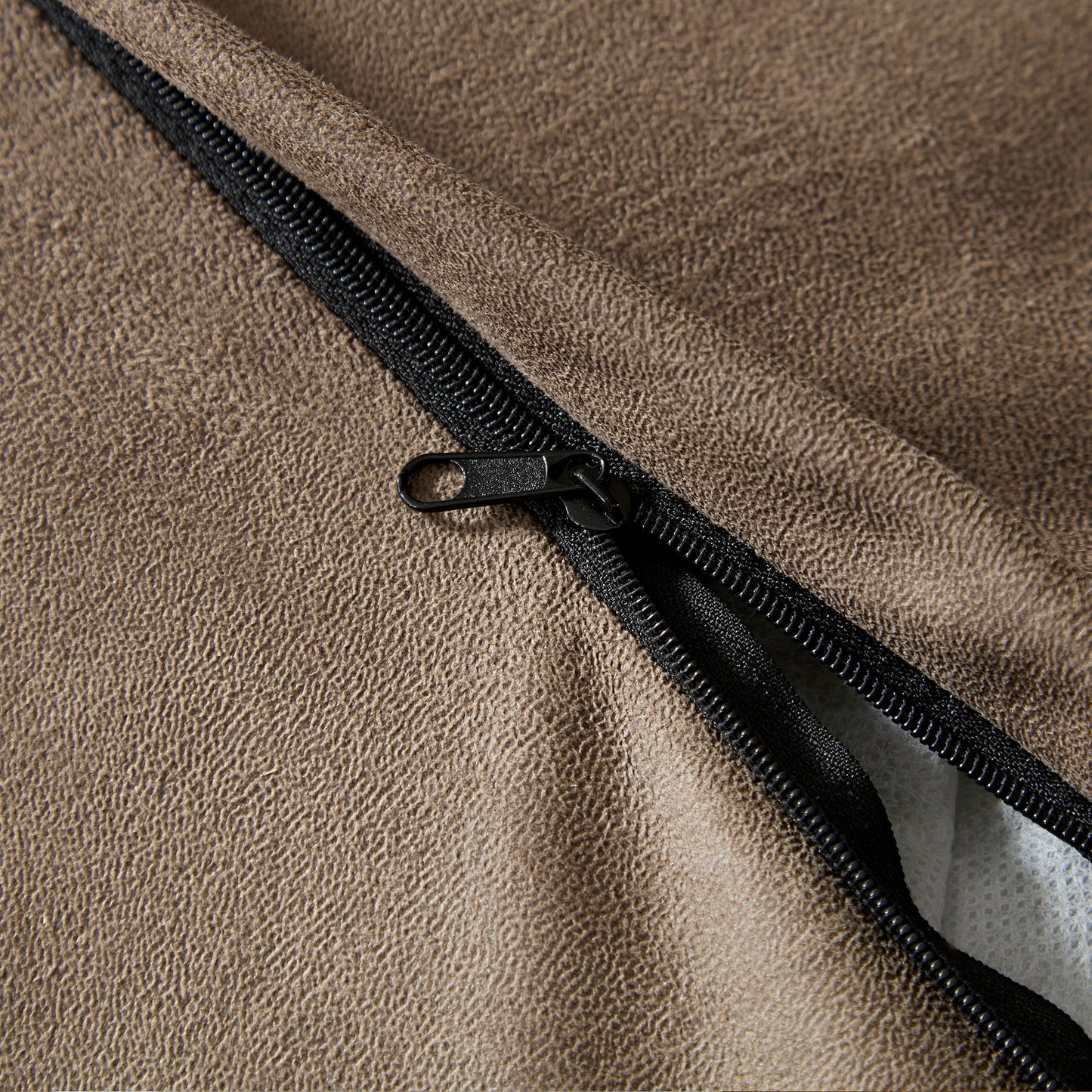 Brown faux leather texture with black zipper detail on a cushion cover