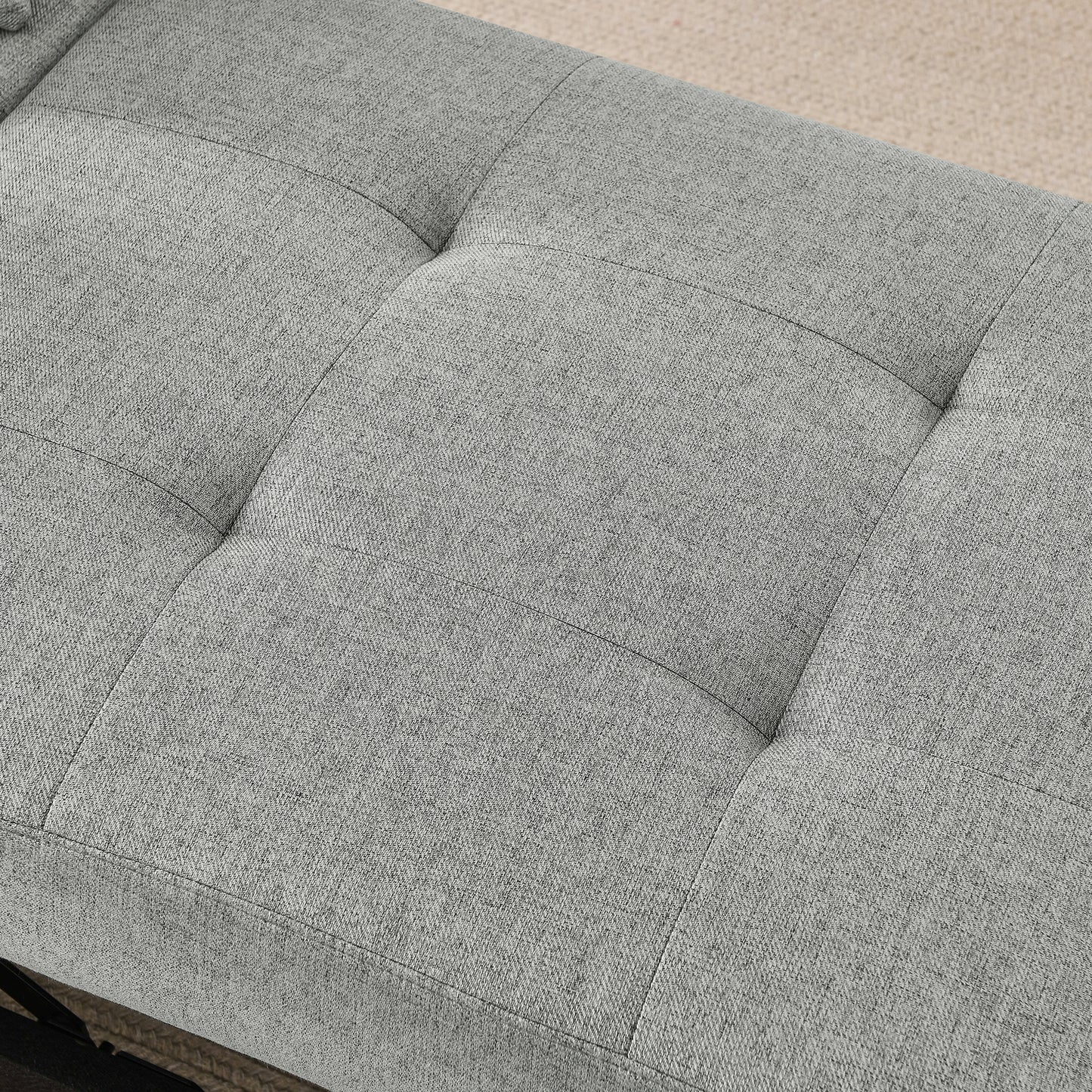 Closeup of a grey textured fabric bench seat with diamond tufting for modern decor