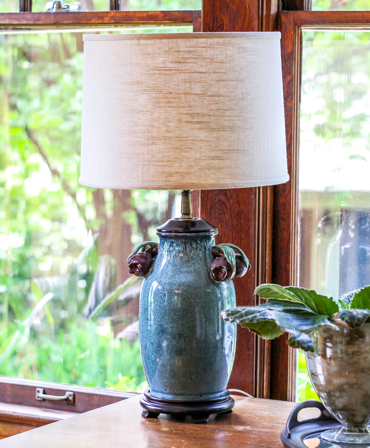 Ocean blue ceramic table lamp with faux cherry accents and natural linen shade