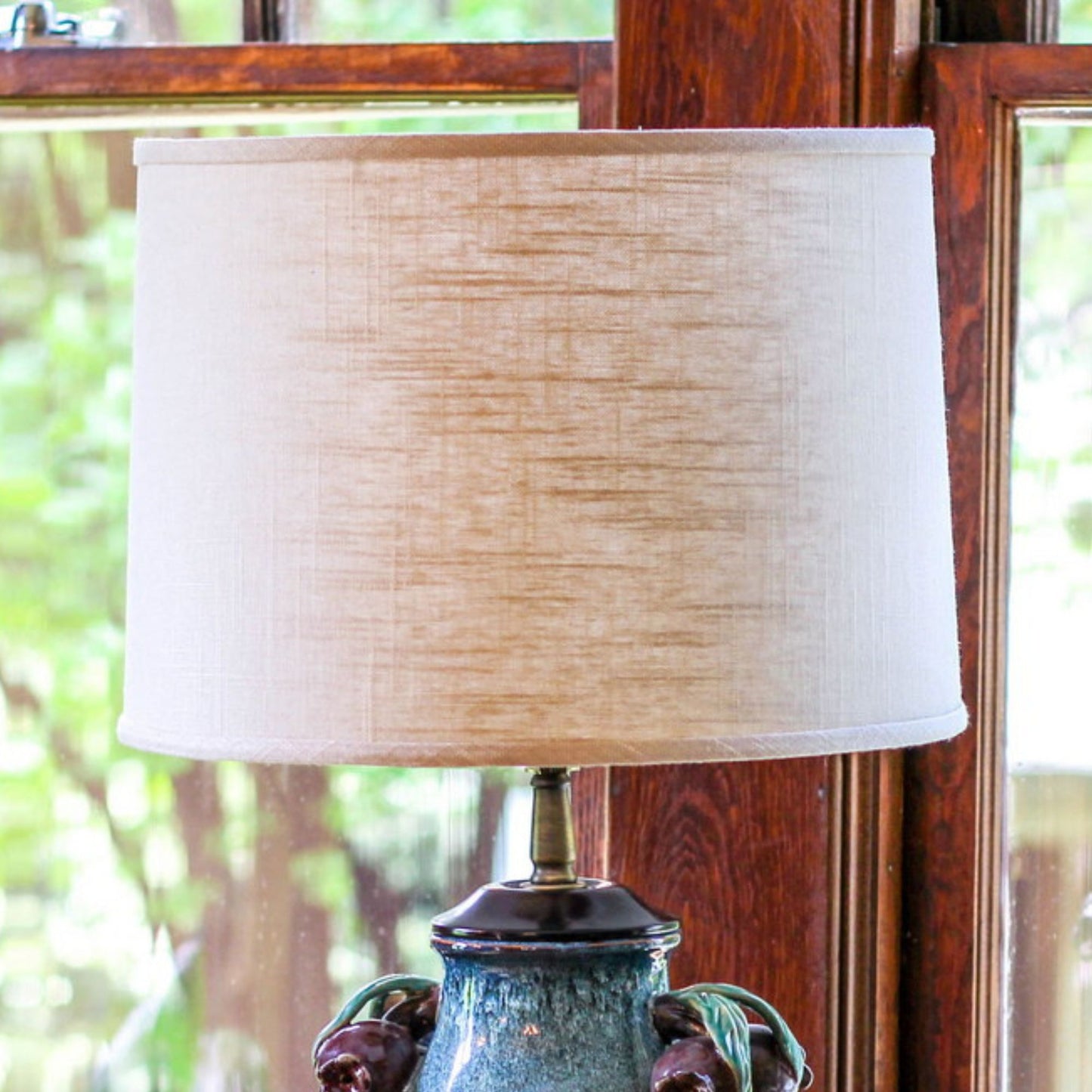 Textured linen lampshade in beige providing soft ambient lighting for living rooms