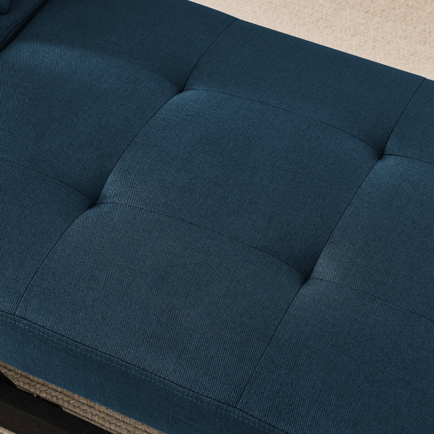 Deep blue fabric ottoman with tufted cushion detail perfect for entryway seating