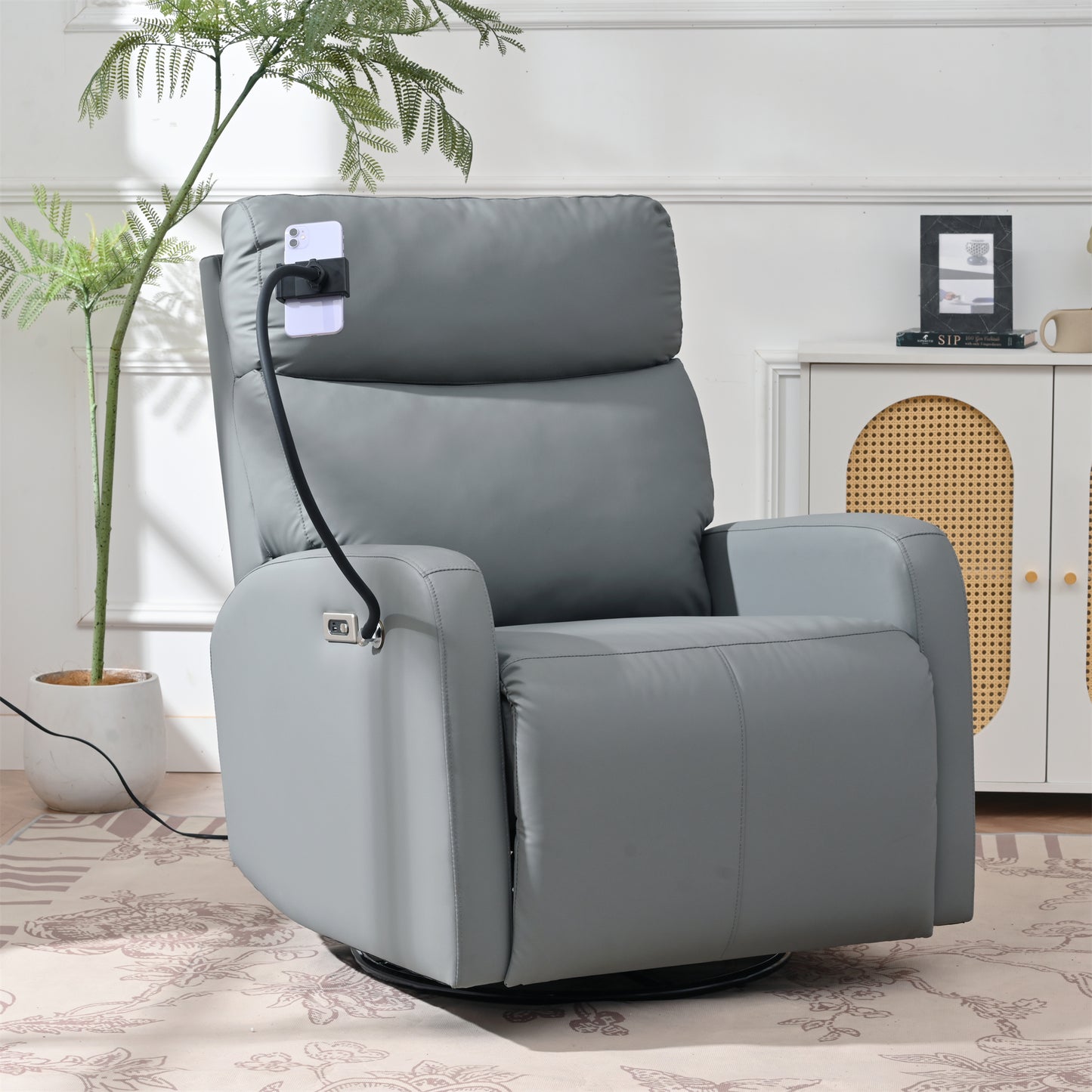 Gray leather power recliner with a swivel base and phone mount