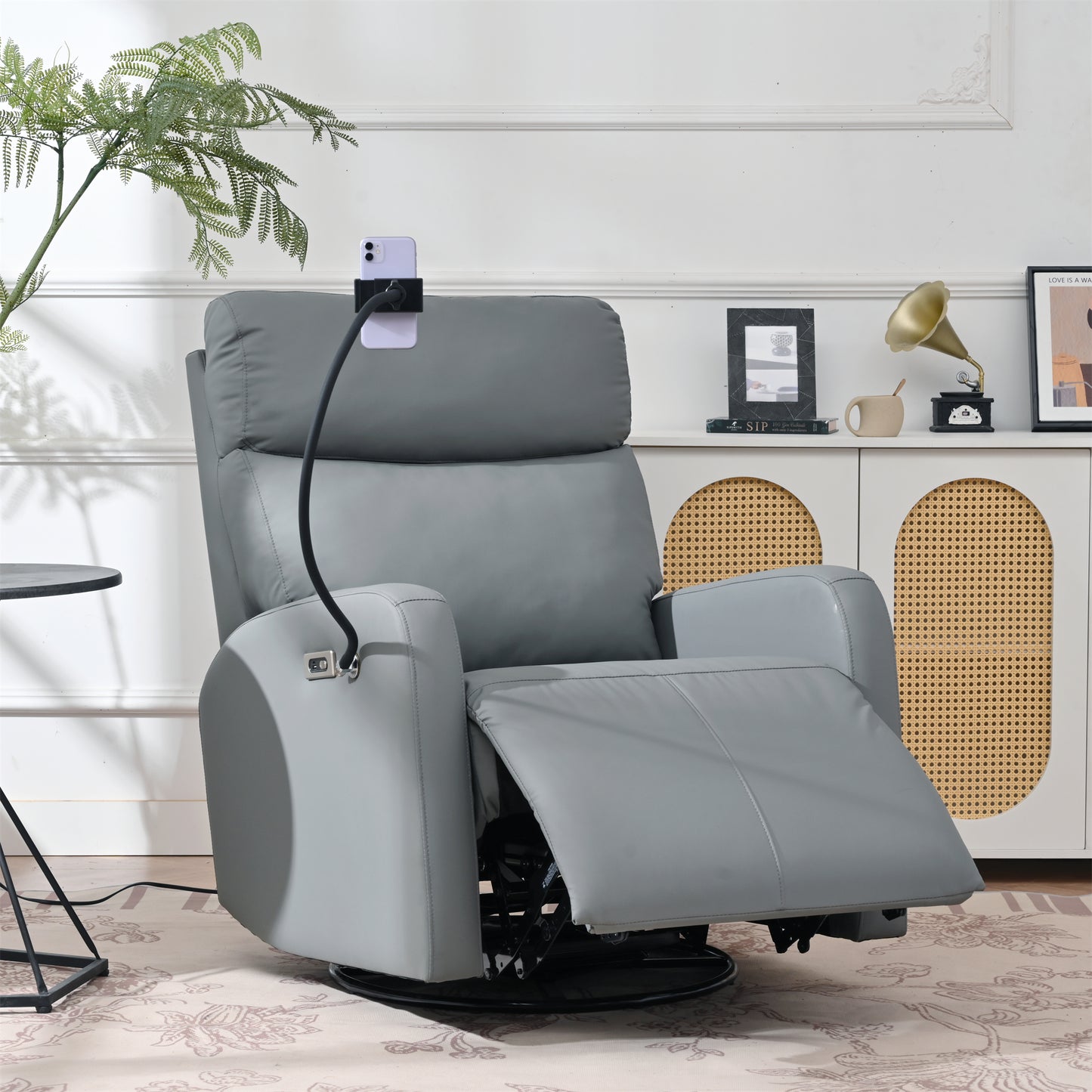 Gray faux leather swivel recliner with adjustable phone holder for entertainment