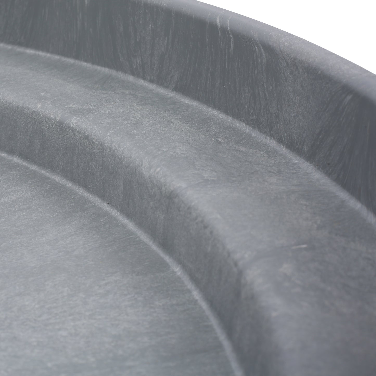 Close up of textured grey plastic basin edge ideal for gardening