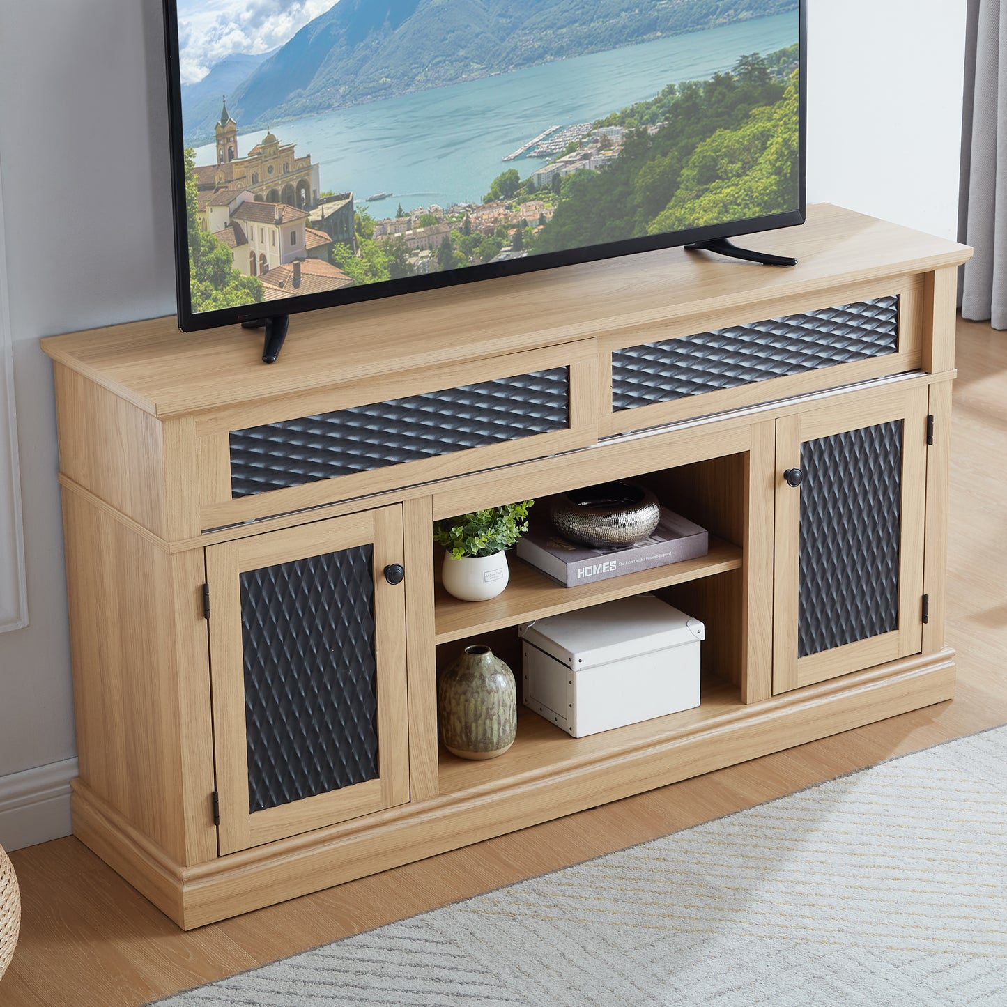 Light oak TV stand with black diamondpatterned doors and open shelving for media storage