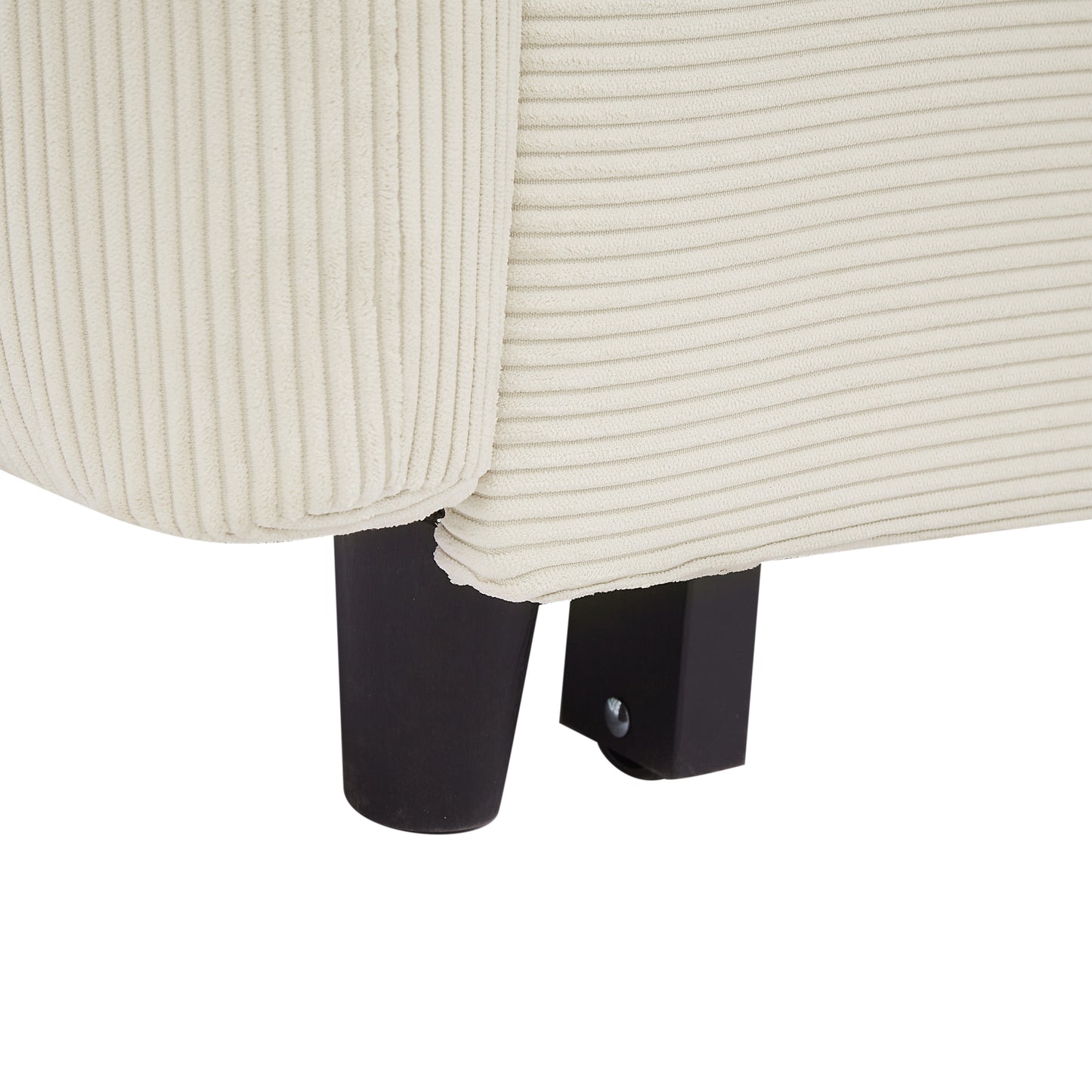 Cream corduroy fabric detail on a chair armrest with dark wood legs
