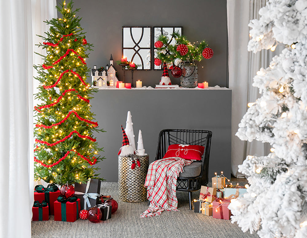 Decorated artificial Christmas tree with red garland and warm white lights