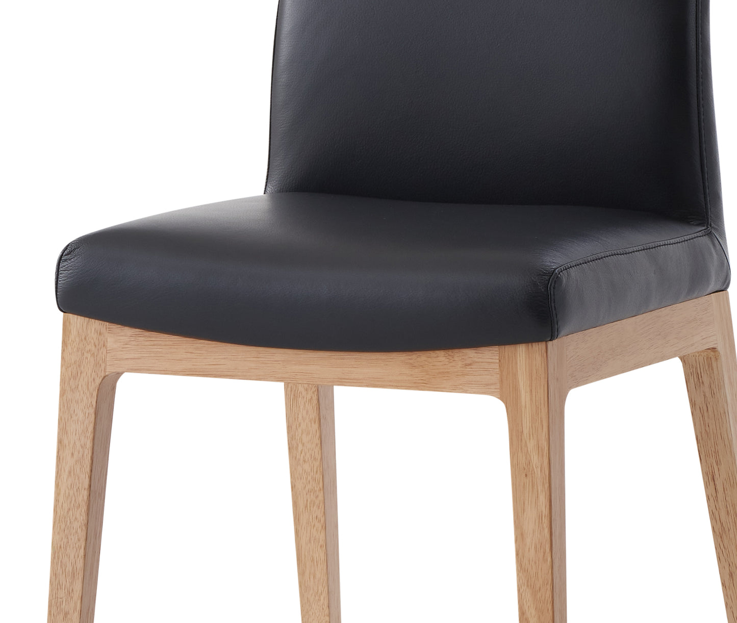 Closeup of a black leather dining chair seat with natural wood legs
