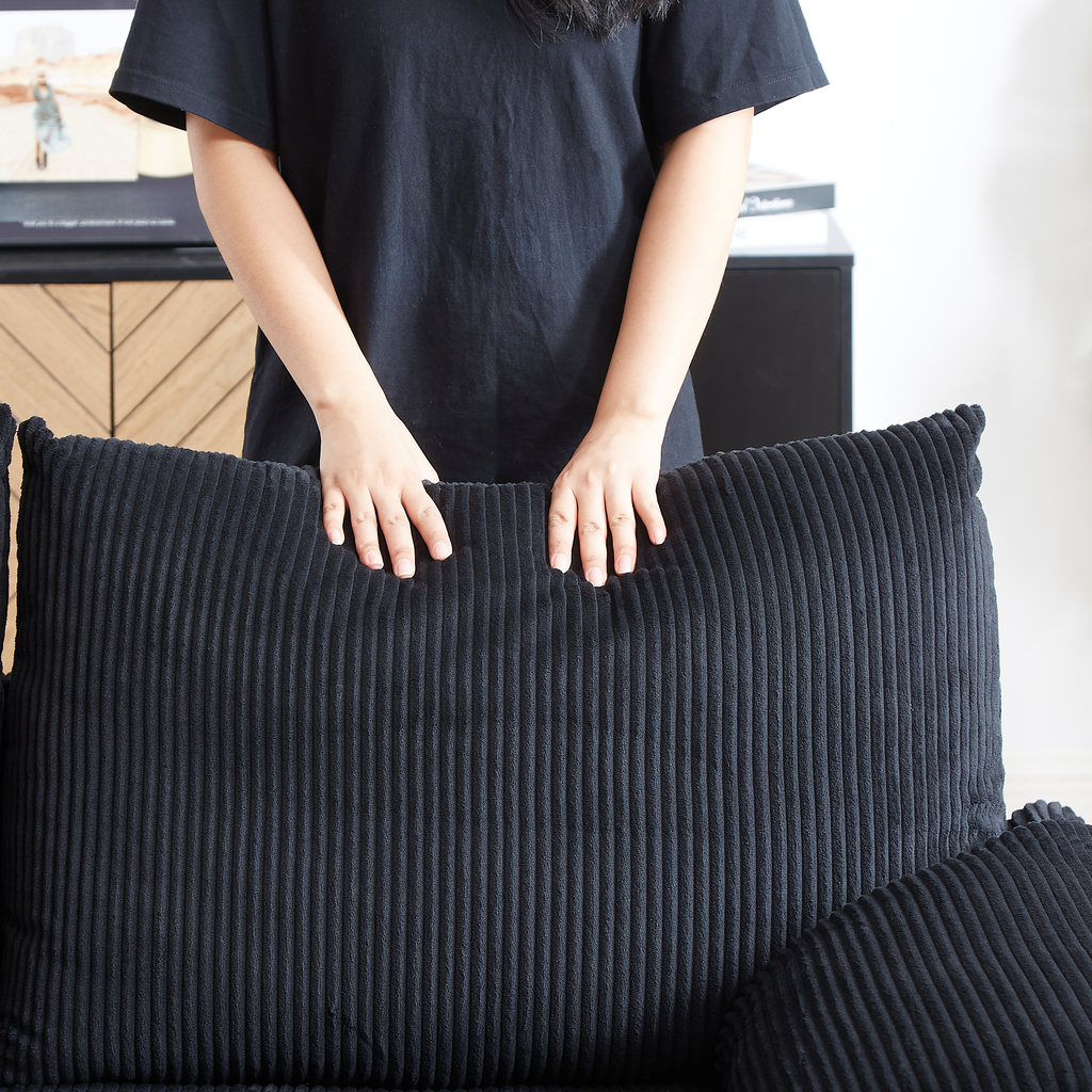 Black corduroy throw pillow with vertical ribbed texture perfect for sofa accents