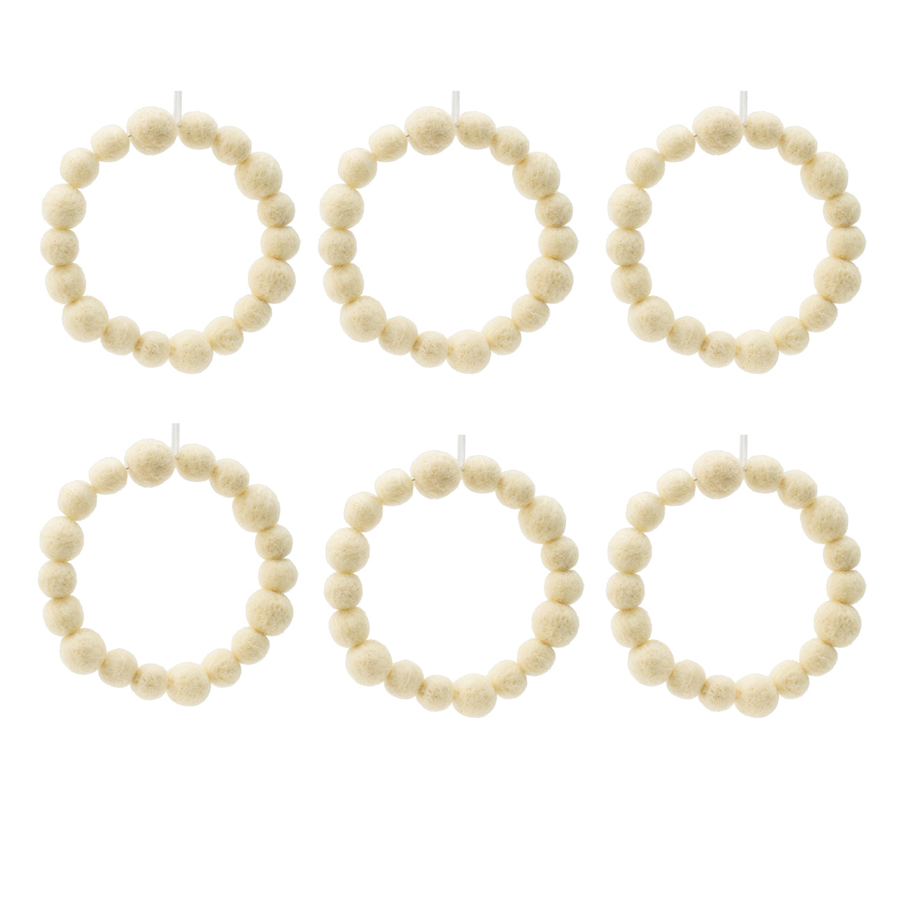 Six cream felt ball wreaths on white background perfect for festive decor