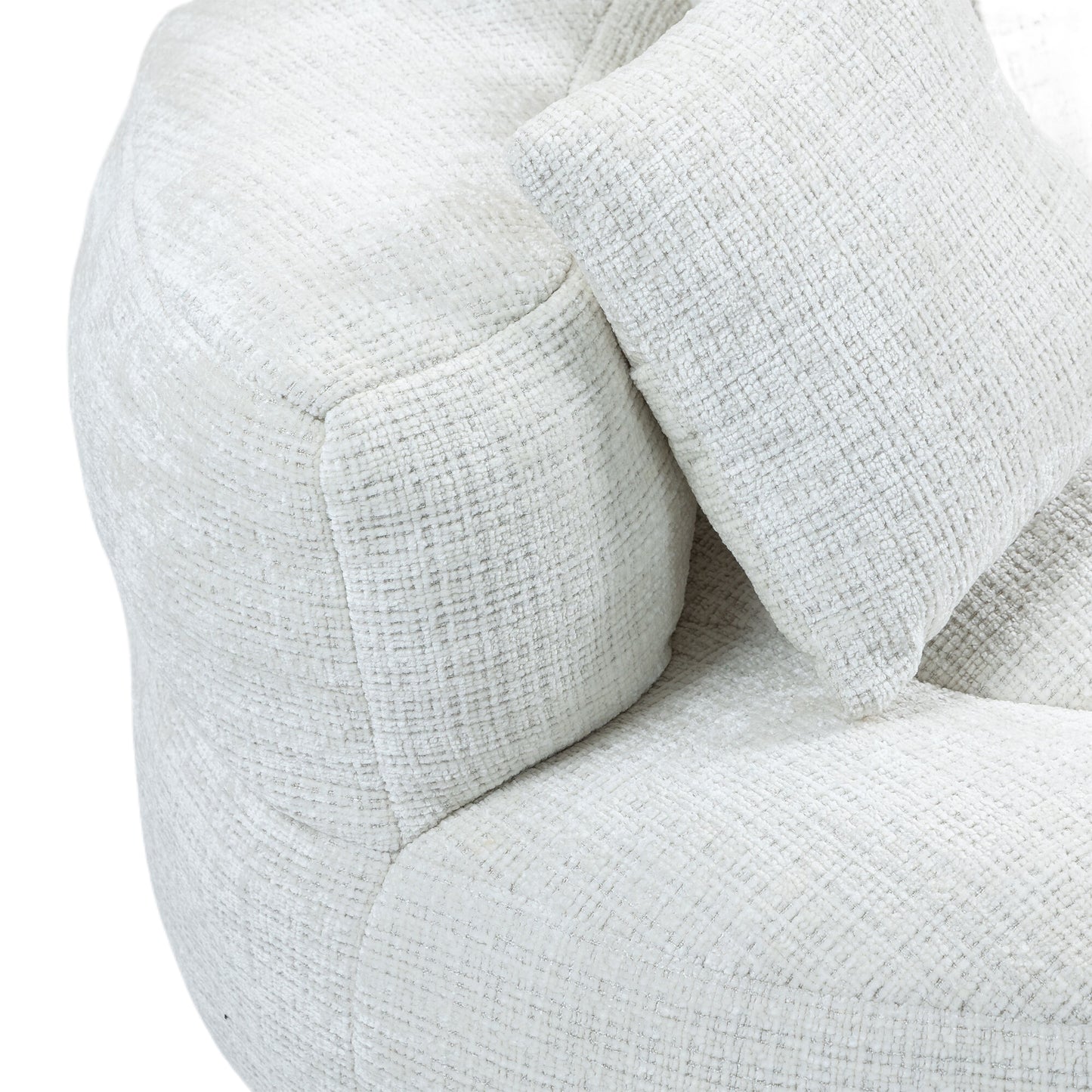Closeup of a plush white boucle armchair with textured fabric and accent pillow