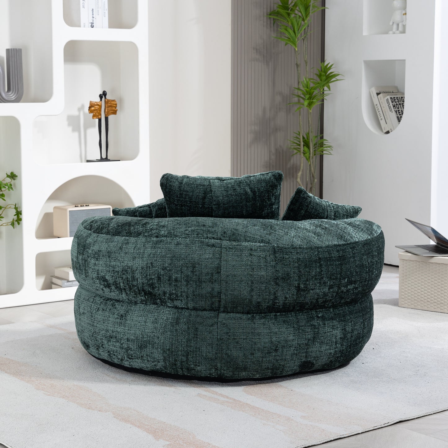 Round teal velvet ottoman with plush cushions perfect for a modern living room