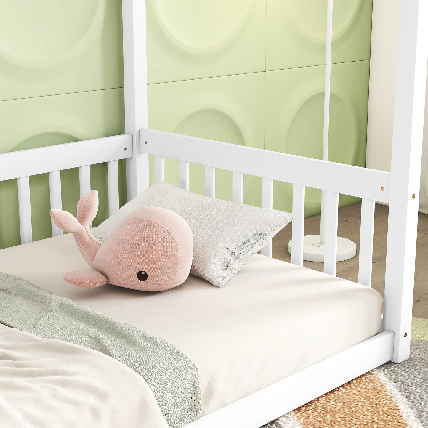 White wooden house bed frame with pastel pink whale plush toy on ivory sheets