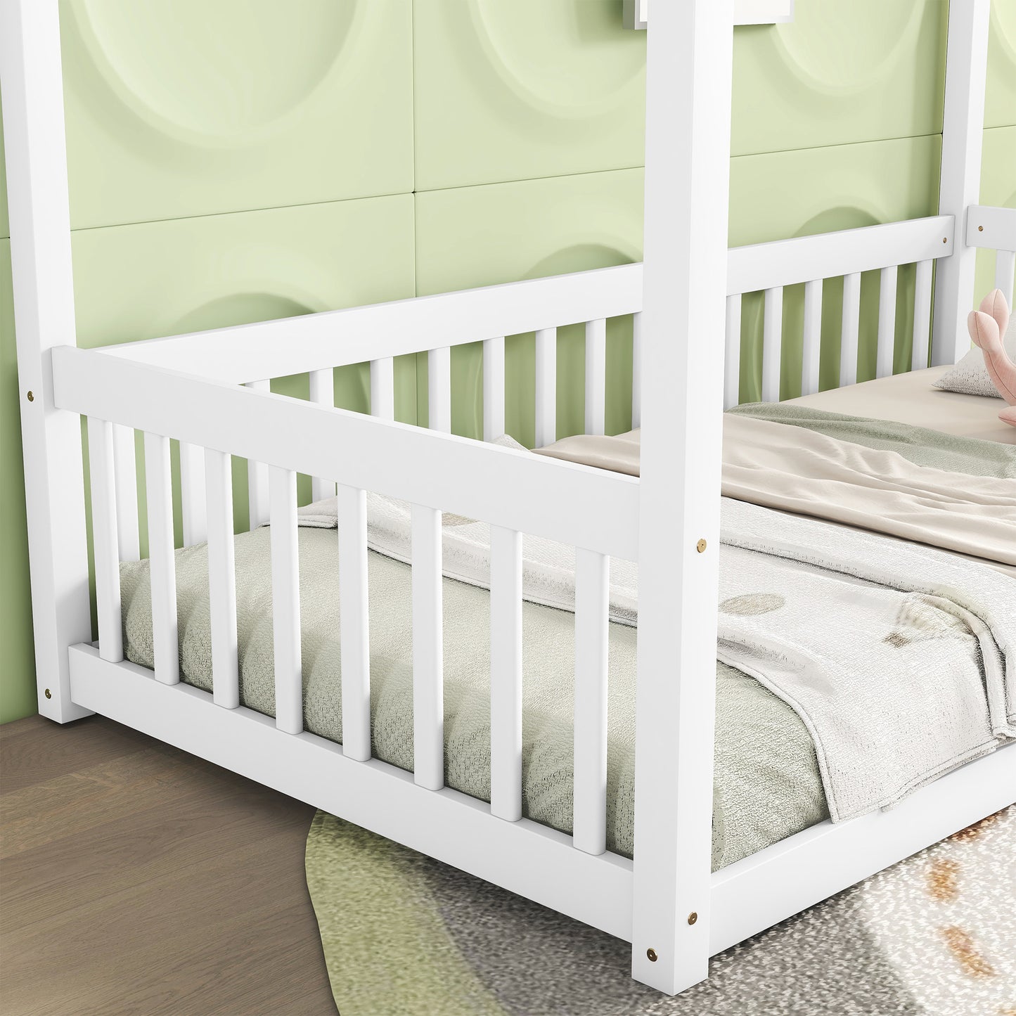 White wooden toddler bed with tall posts and safety rails