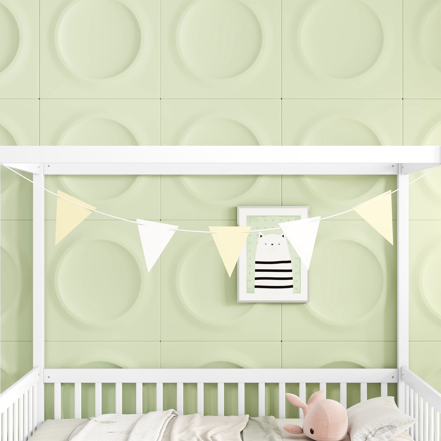White wood Montessori bed with pastel bunting and a framed cat picture