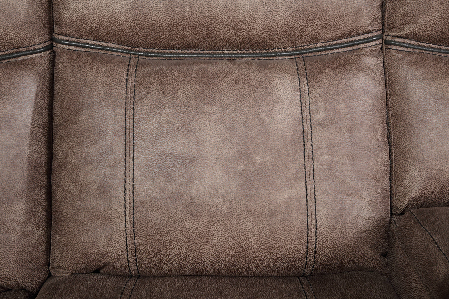 Closeup of a plush brown recliner seat with detailed stitching