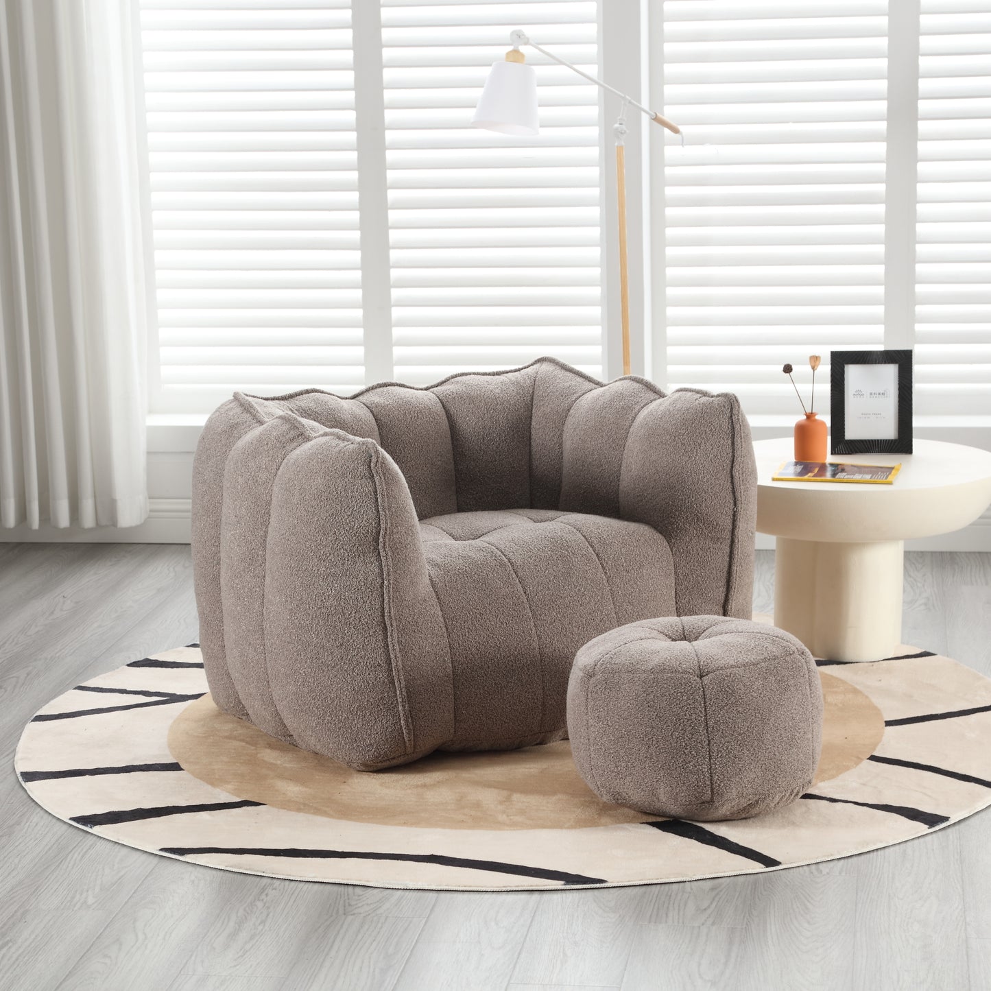 Textured taupe boucle armchair with matching ottoman perfect for cozy living rooms