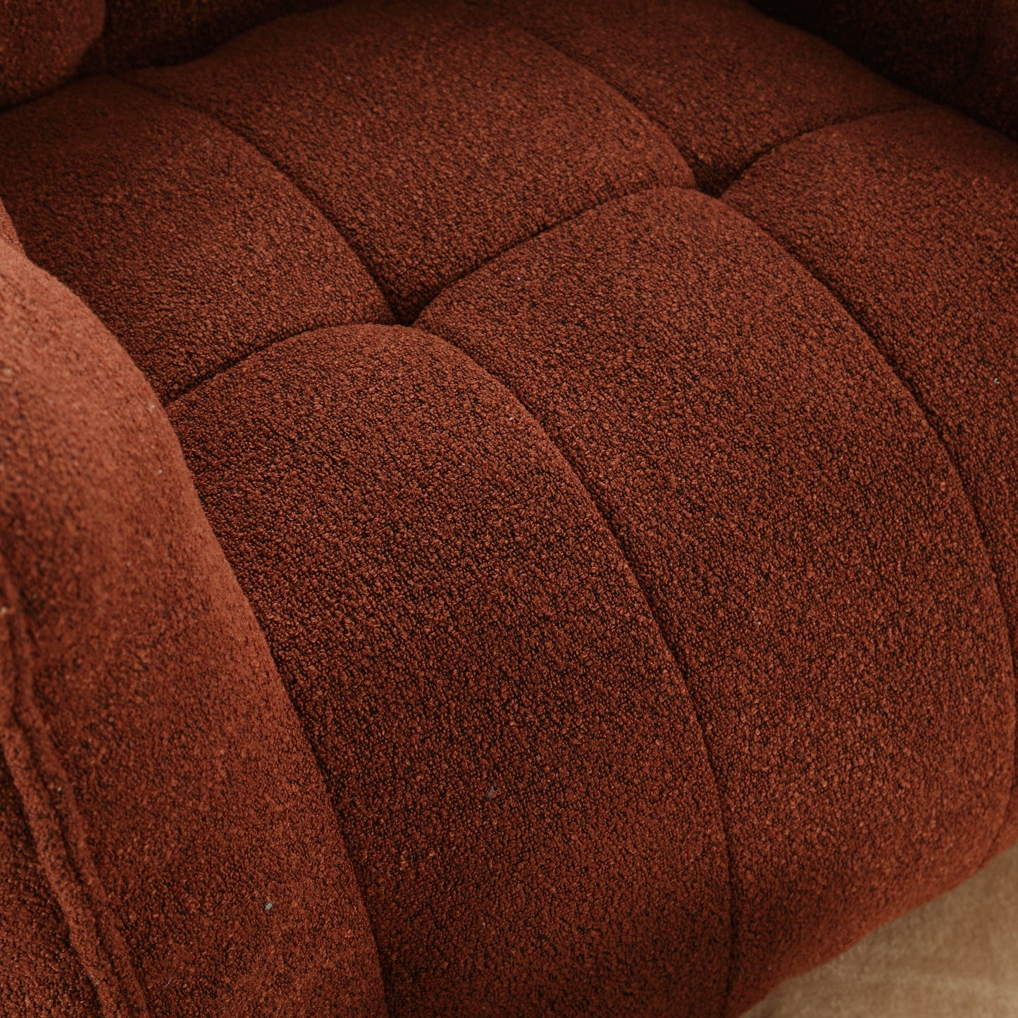 Textured rust fabric sofa detail with deep button tufting for plush comfort