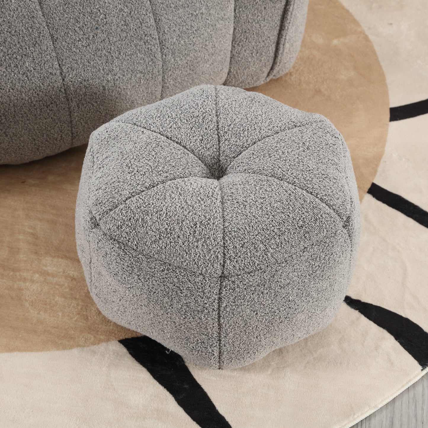 Textured grey fabric ottoman with stitched panel design perfect for living room seating