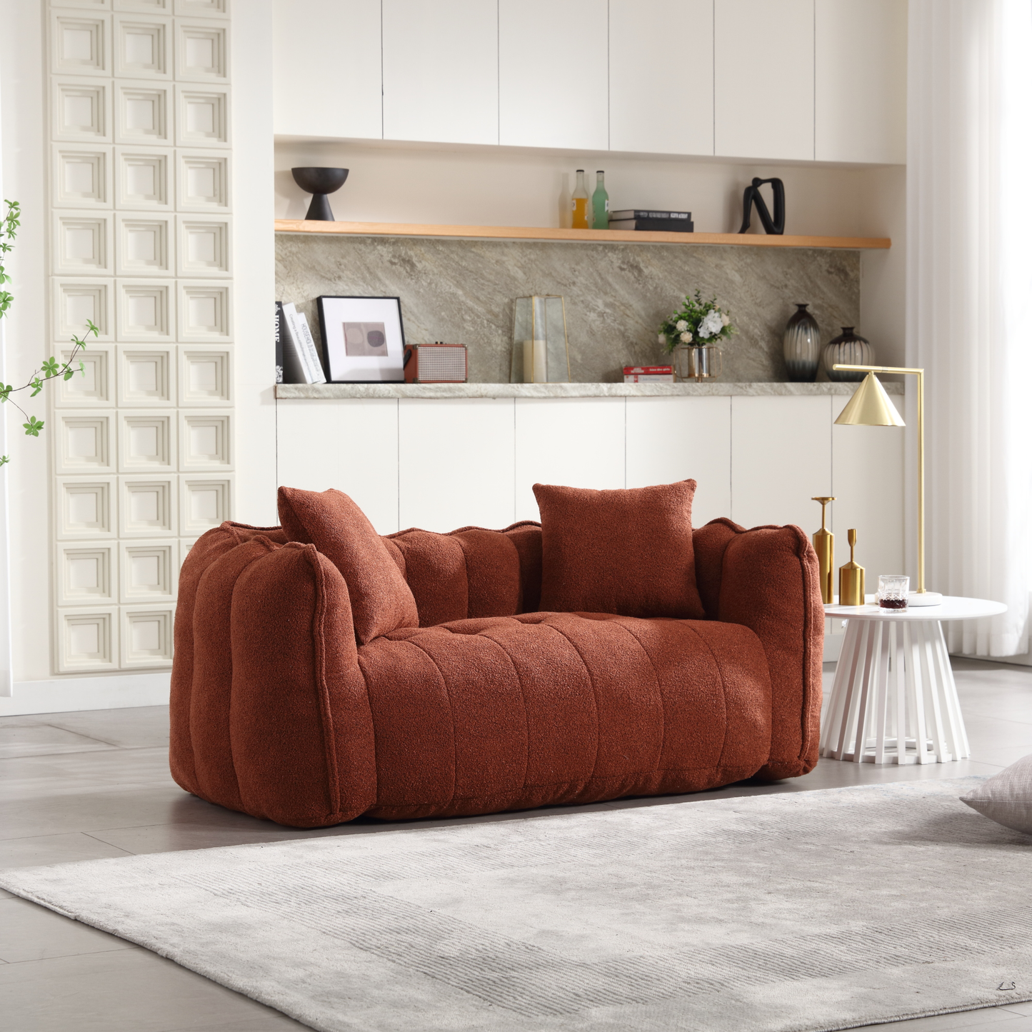 Plush boucle fabric sofa in burnt orange with channel tufting and matching throw pillows