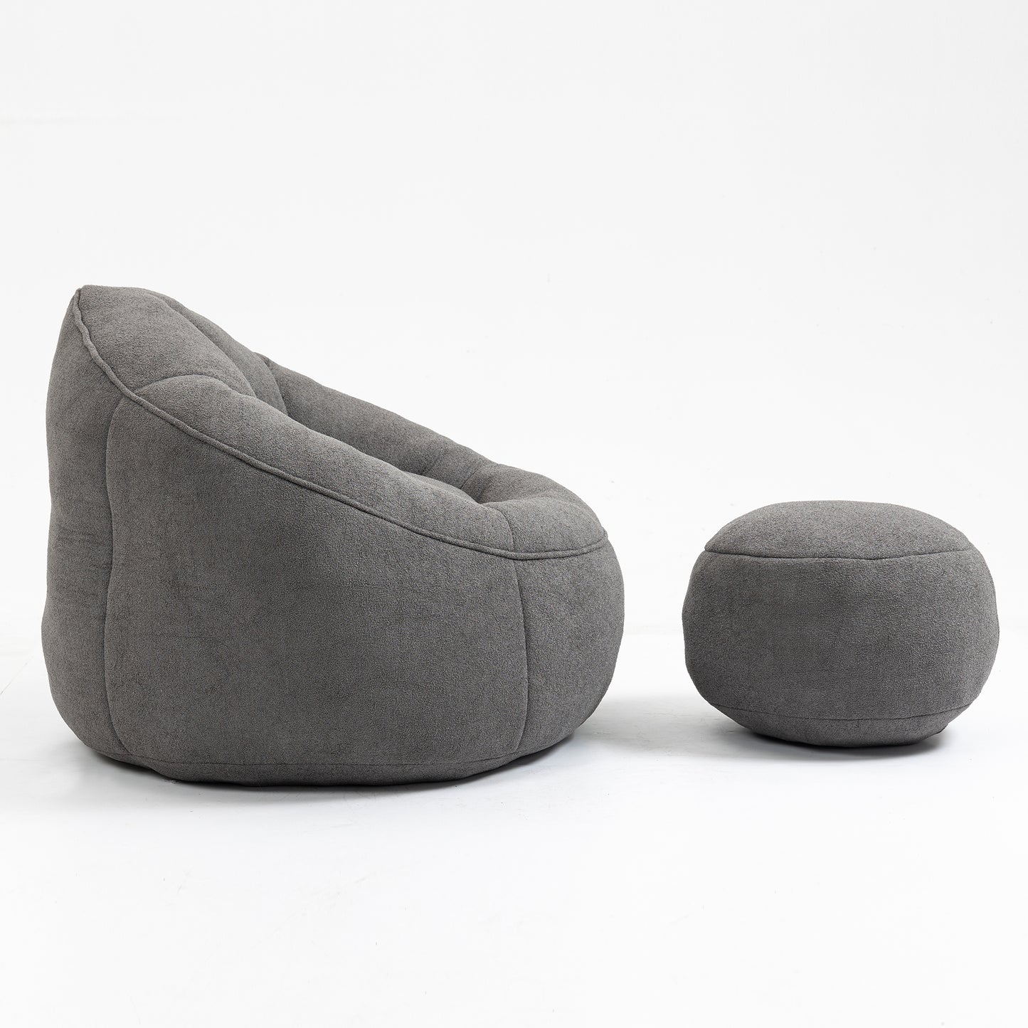 Dark grey tufted bean bag chair and matching ottoman made from soft fabric