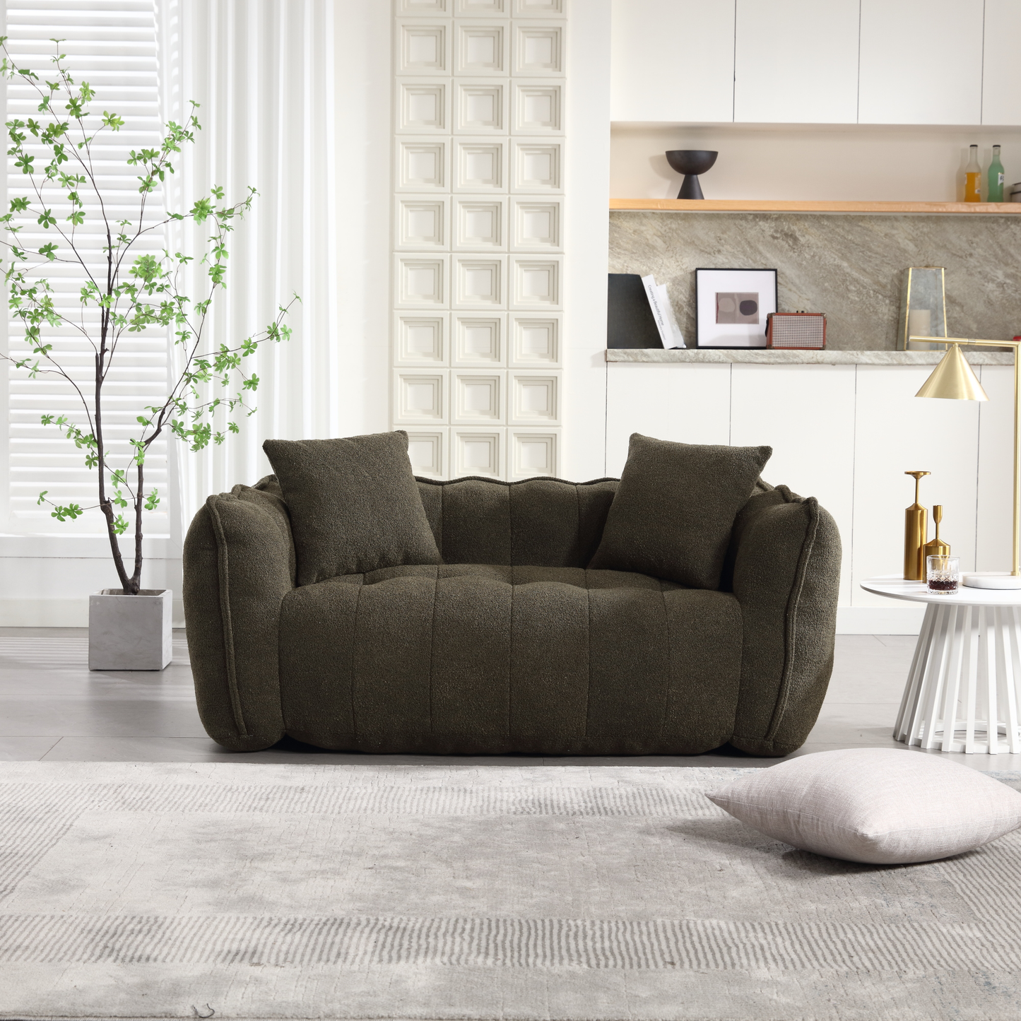 Plush dark green boucle sofa with two matching throw pillows perfect for modern living rooms