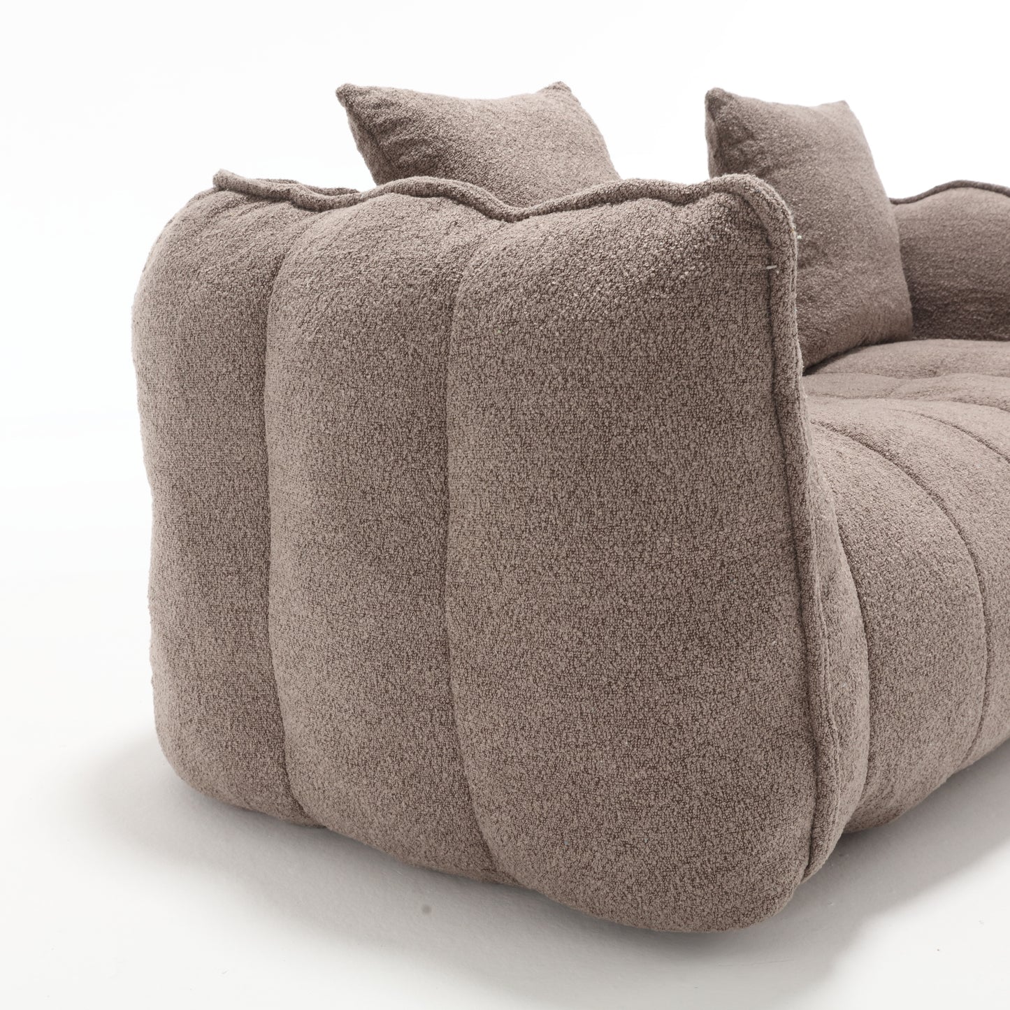Textured taupe modular sofa section with soft rounded edges and plush cushioning
