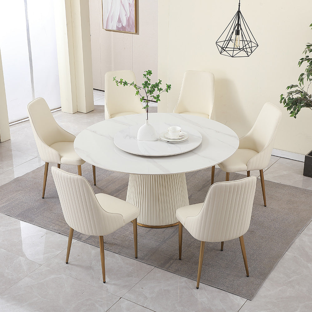 Round marble dining table with plush cream chairs and gold legs