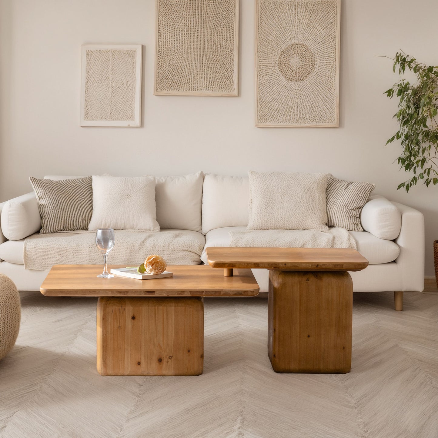 Modern living room with a white sofa natural wood coffee tables and textured wall art