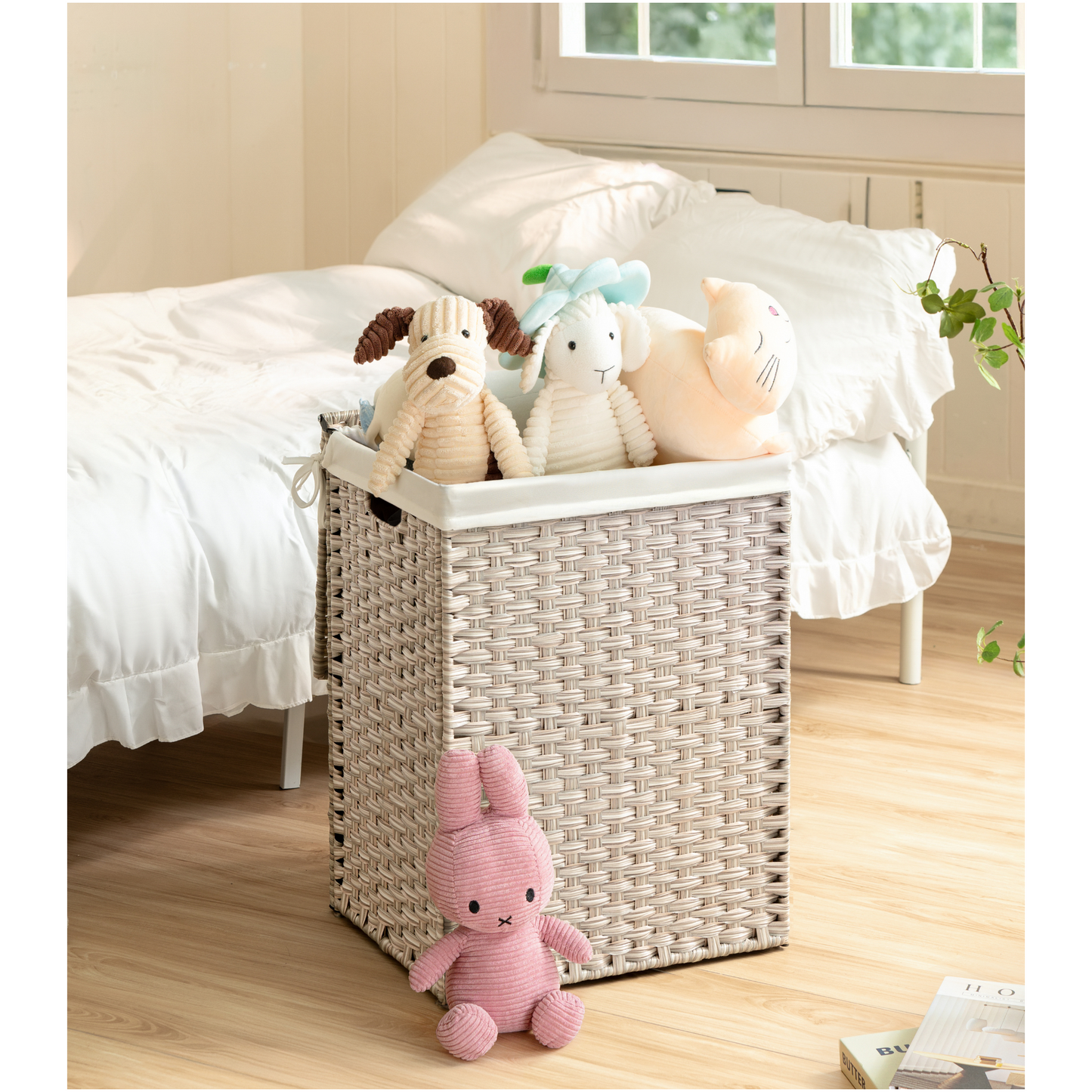 Woven storage basket with stuffed dog sheep and cat toys for nursery organization