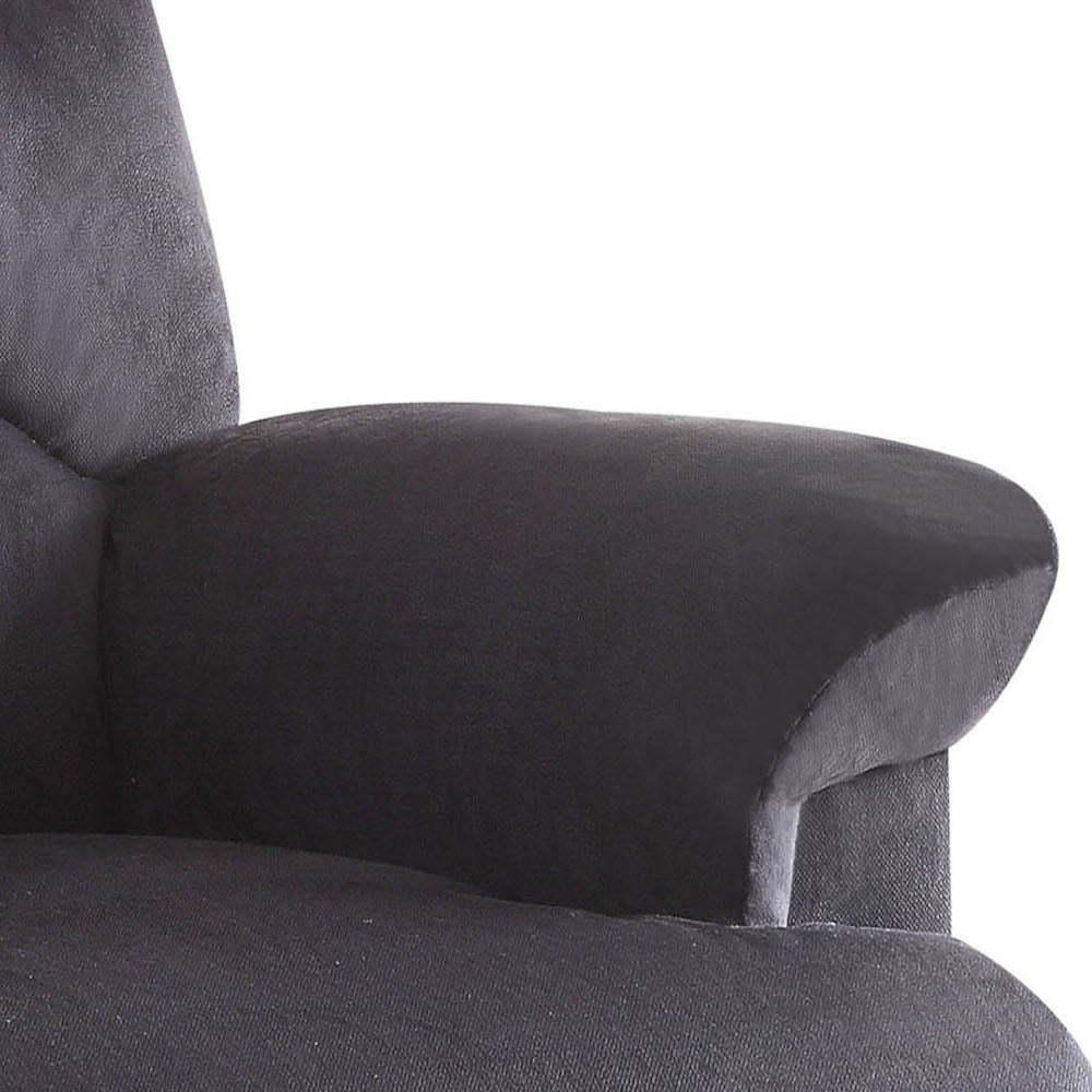 Closeup of a dark gray upholstered armchair armrest with textured fabric