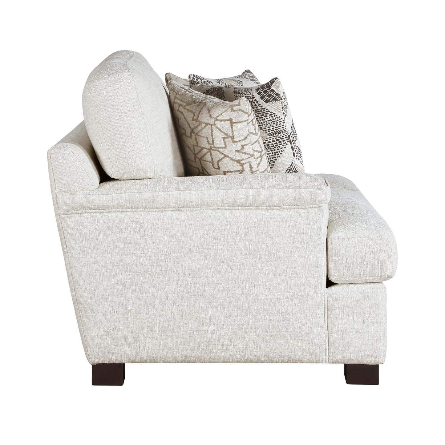 Cream textured armchair with patterned throw pillows for a cozy living room