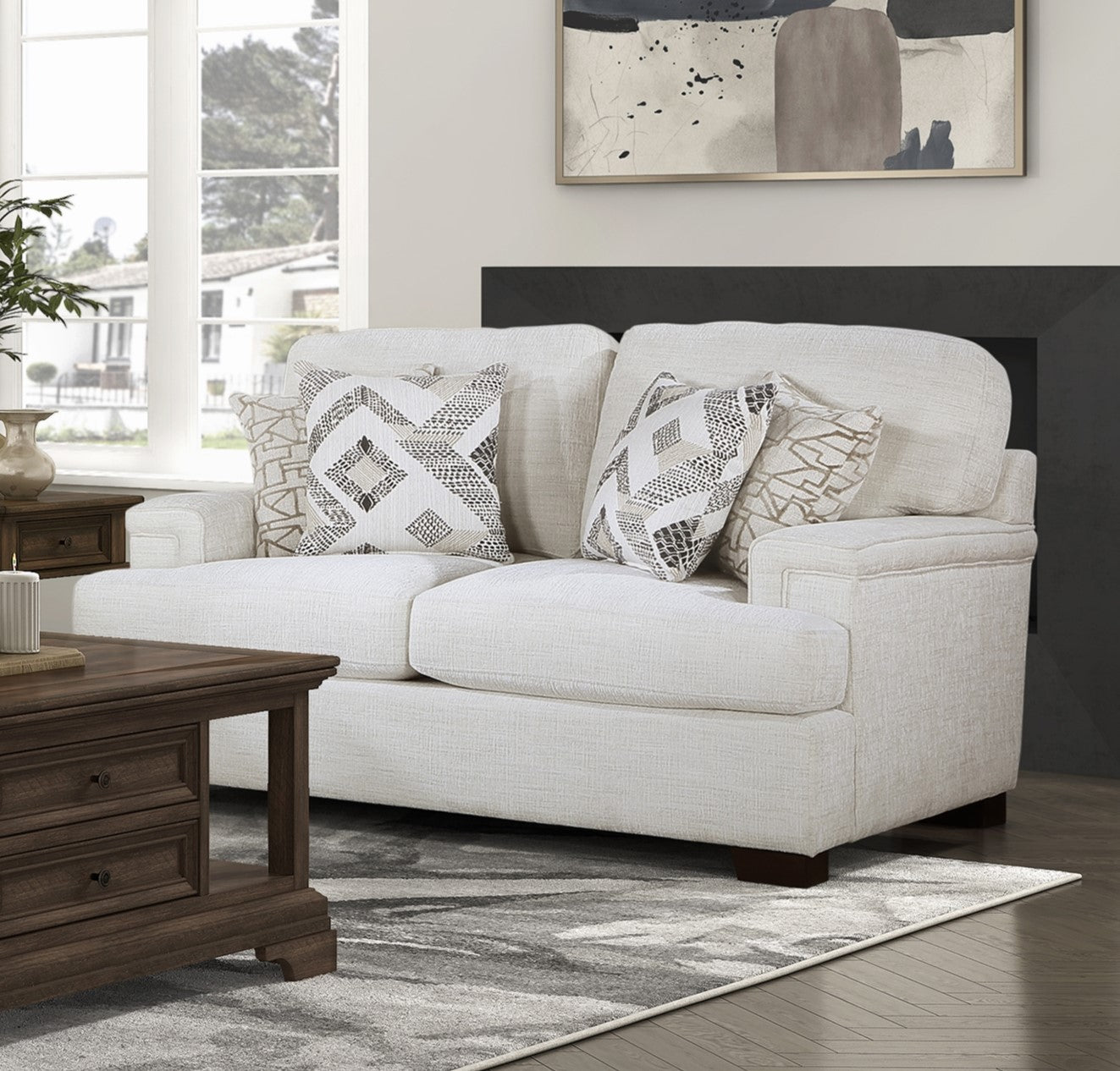 Cream fabric loveseat with geometric accent pillows perfect for a modern living room