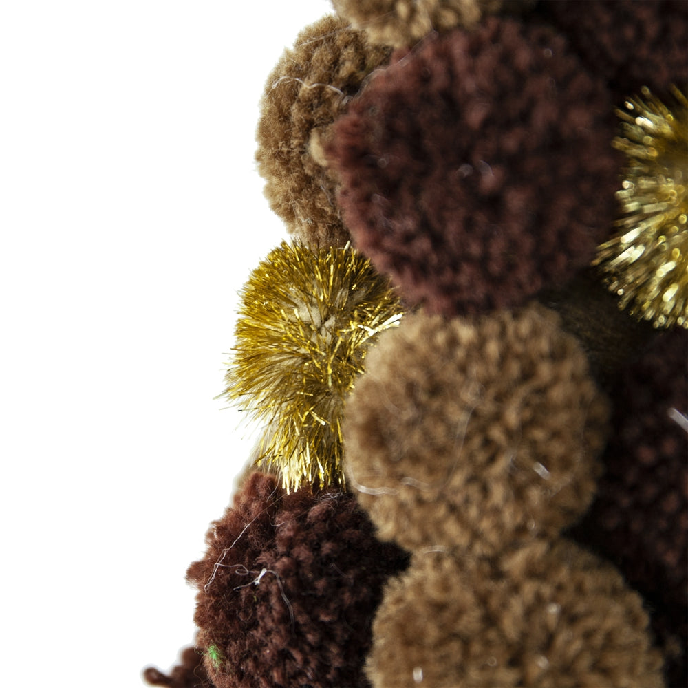 Closeup of brown and gold pom pom garland with textured yarn