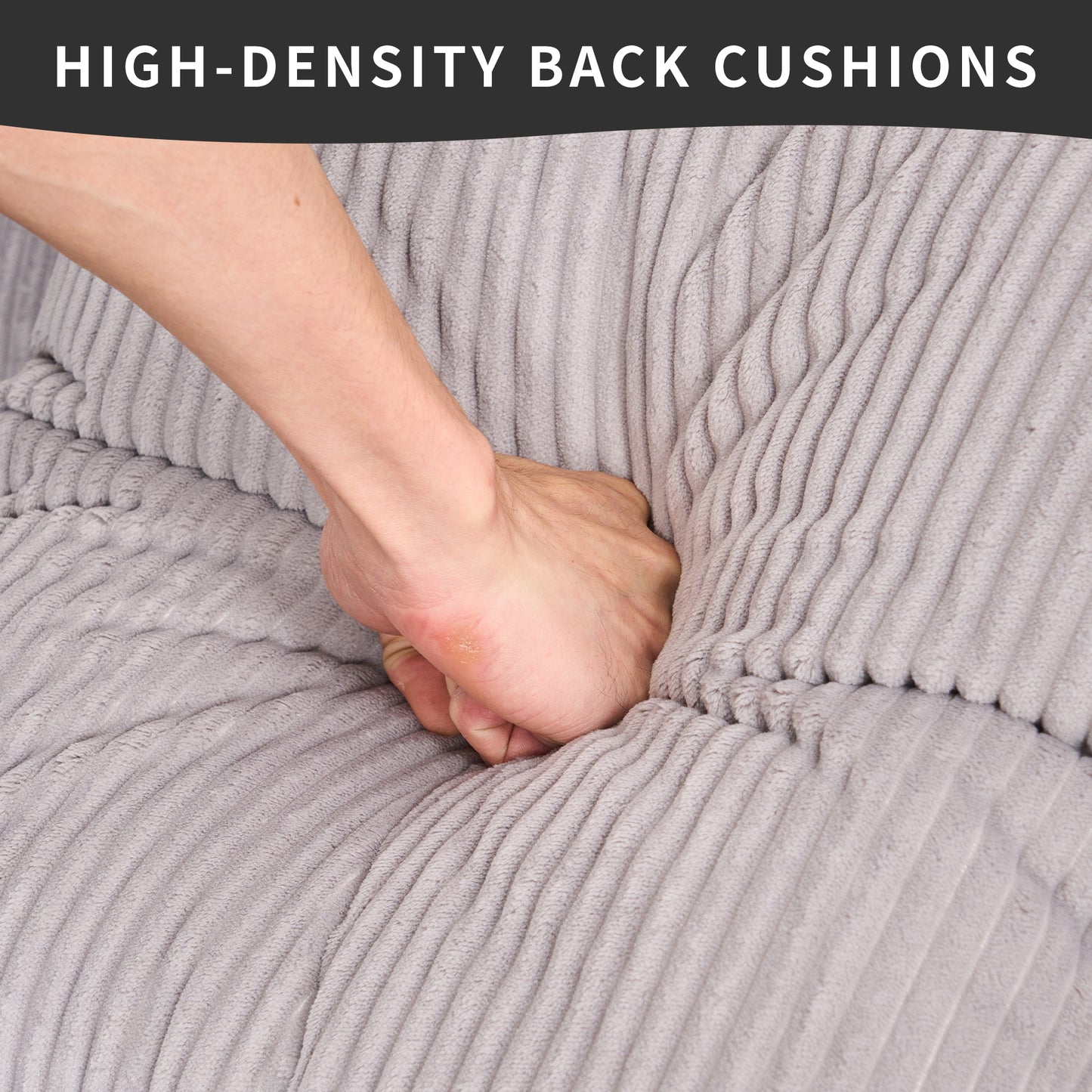 Hand pressing into soft grey corduroy sofa cushions demonstrating highdensity comfort
